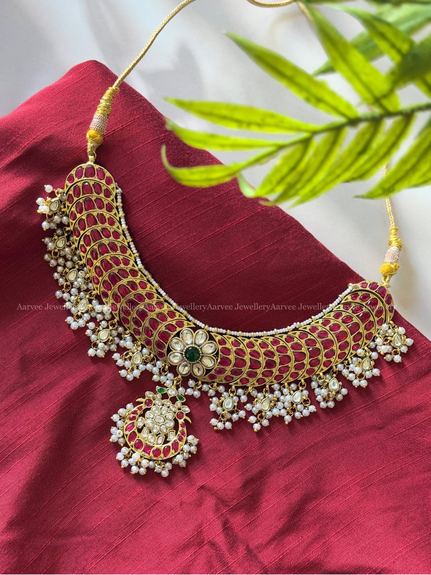 JADAU KUNDAN RUBY STONE CRESCENT NECKLACE WITH FLORAL PENDANT AND WHITE STONE DROPS