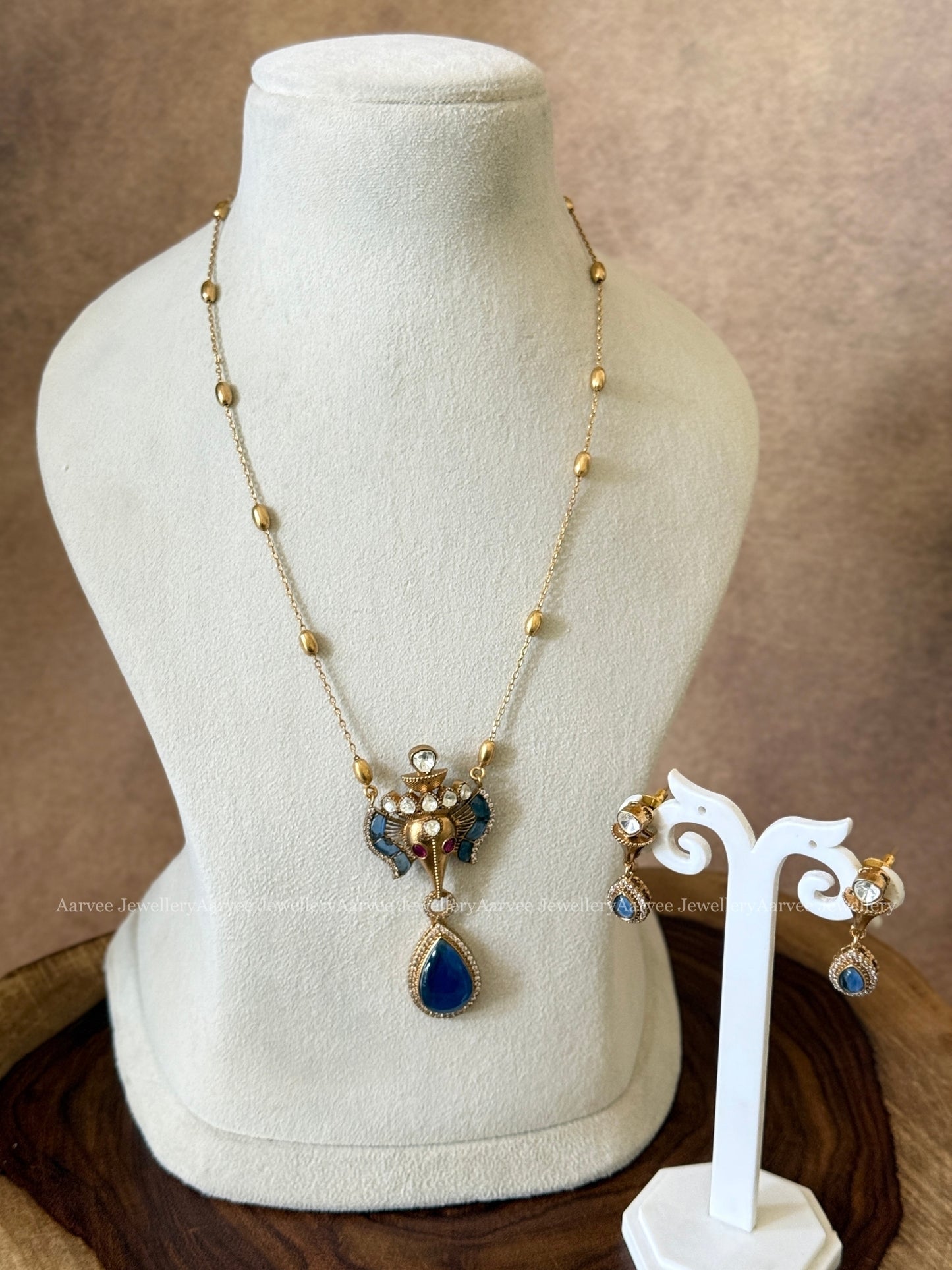 GOLD MID LENGTH CHAIN SET WITH ELEPHANT PENDANT IN BLUE STONES