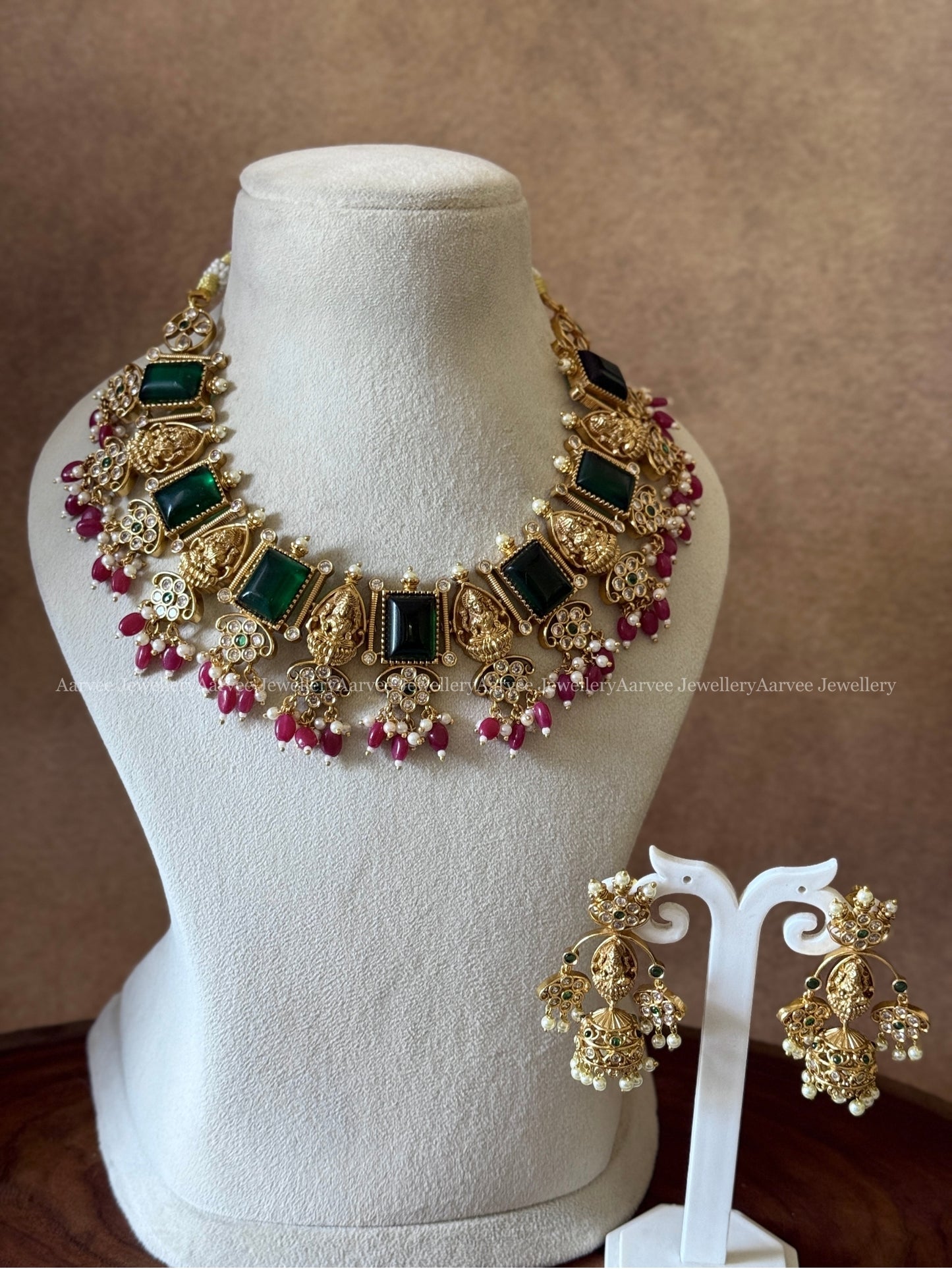GOLD FINISH LAKSHMI AND GREEN STONE NECKLACE SET WITH RUBY BEADS