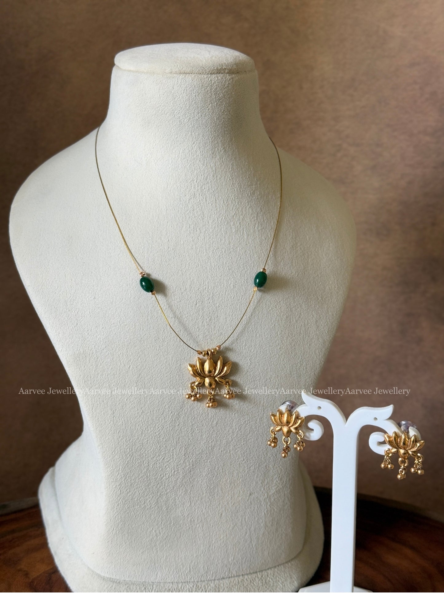 DELICATE INVISIBLE CHAIN SET WITH GOLD TONE LOTUS PENDANT