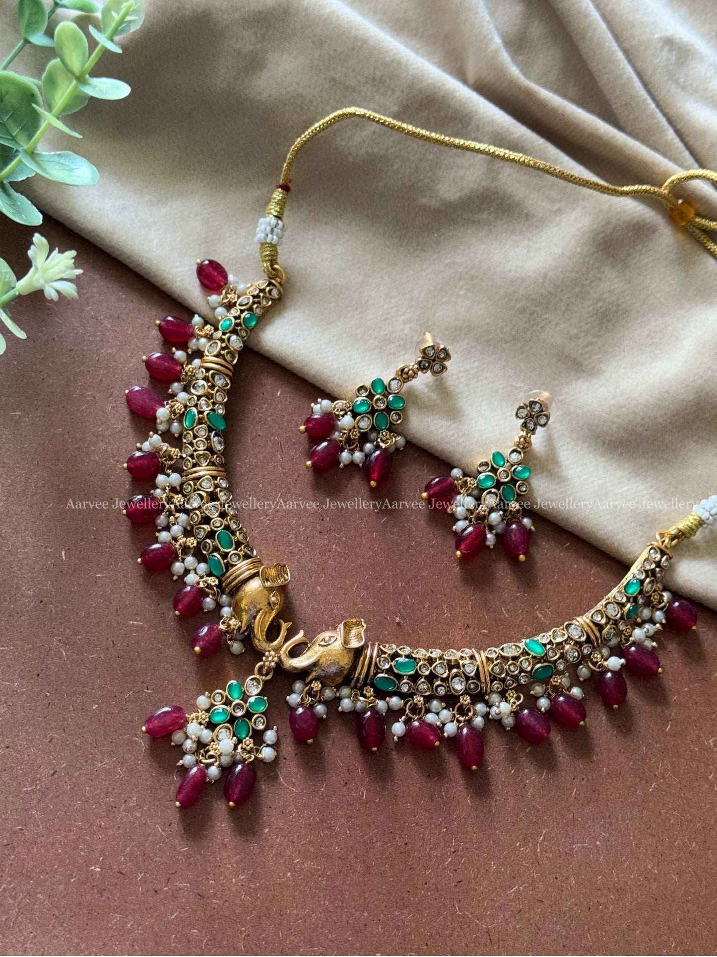 ELEPHANT KANTI NECKLACE SET WITH GREEN STONE AND RUBY BEADS
