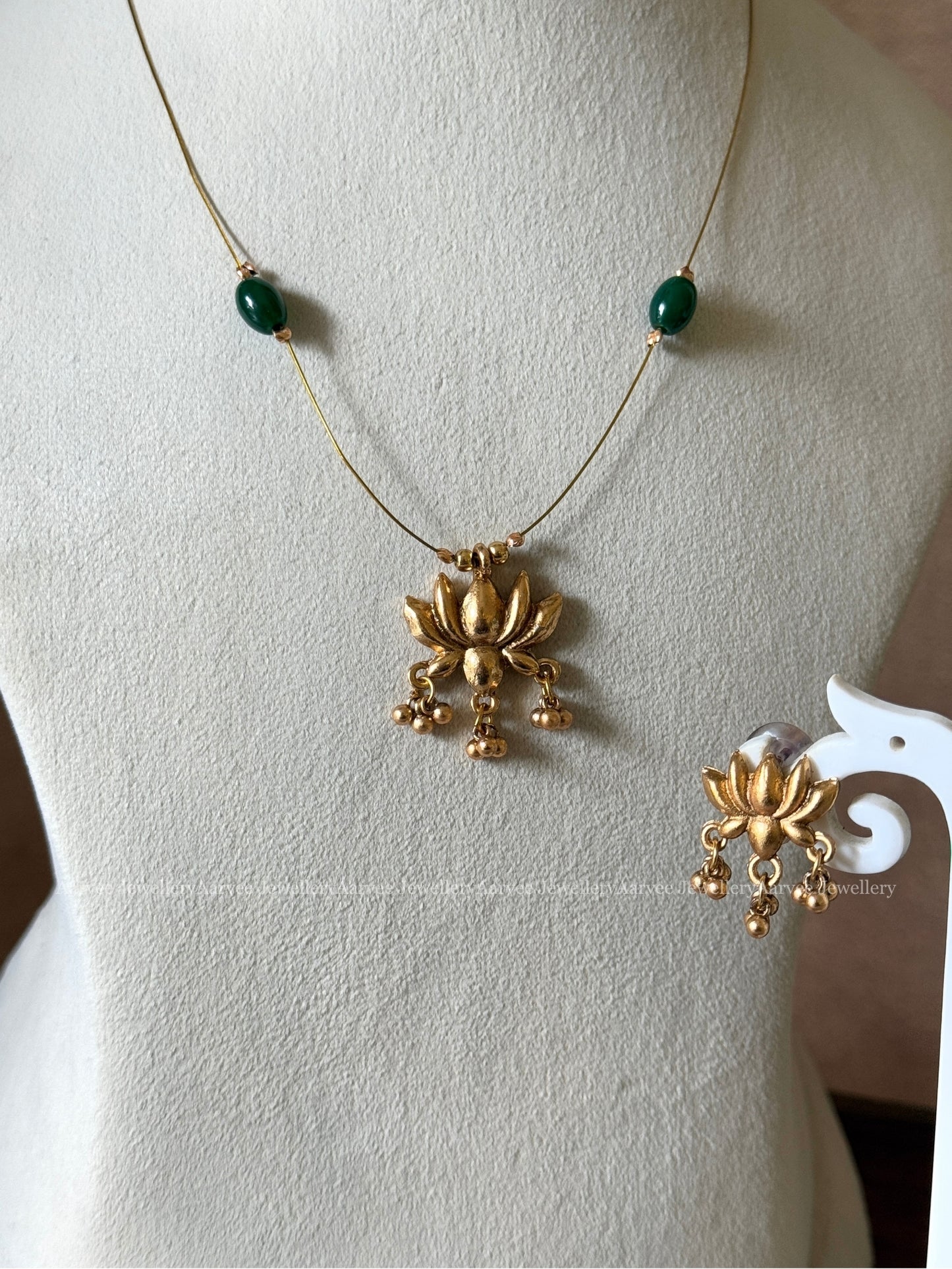DELICATE INVISIBLE CHAIN SET WITH GOLD TONE LOTUS PENDANT