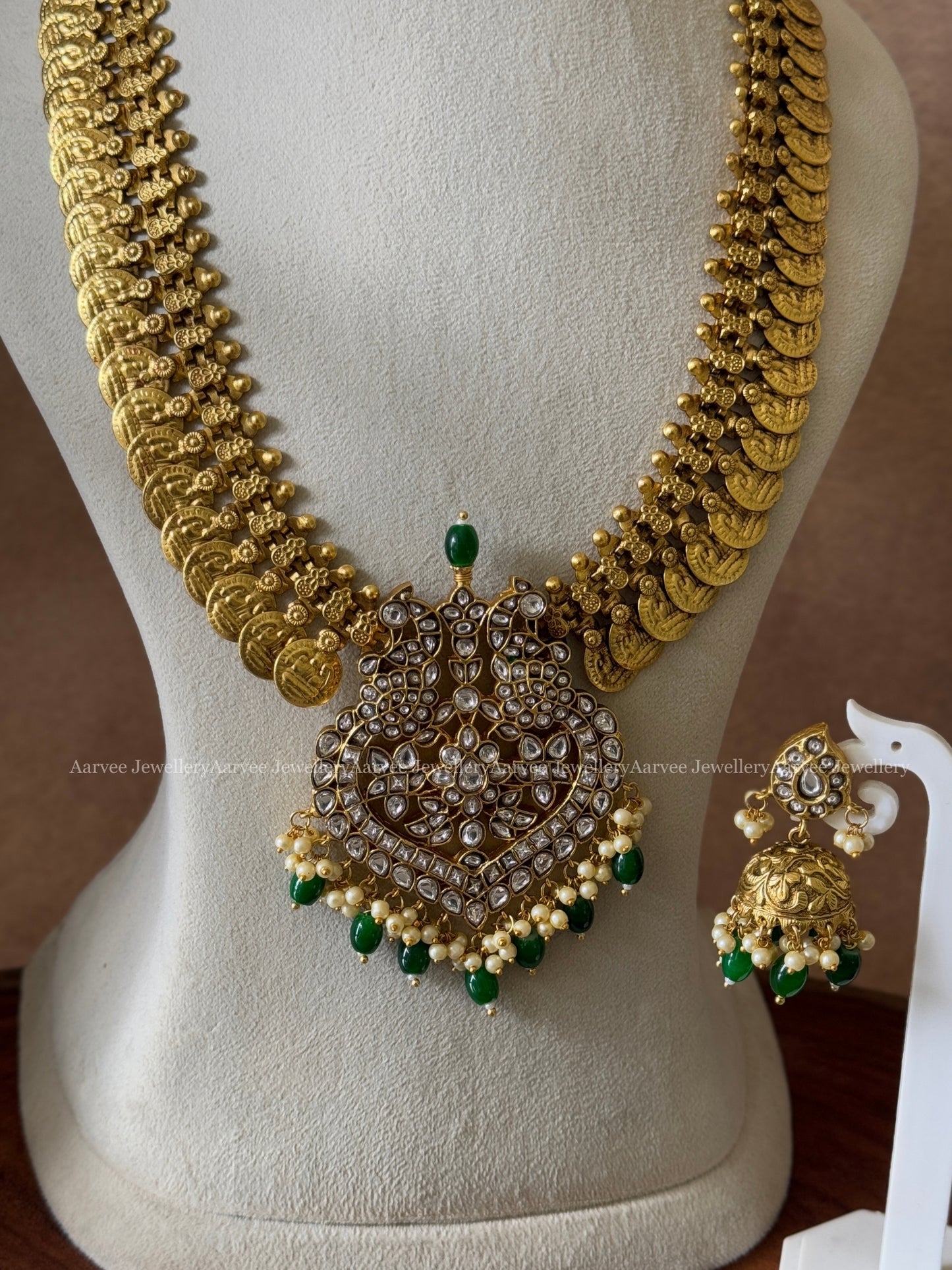 COIN MIDLENGTH CHAIN WITH JADAU KUNDAN WHITE STONE PEACOCK PENDANT & JHUMKI IN GREEN BEADS