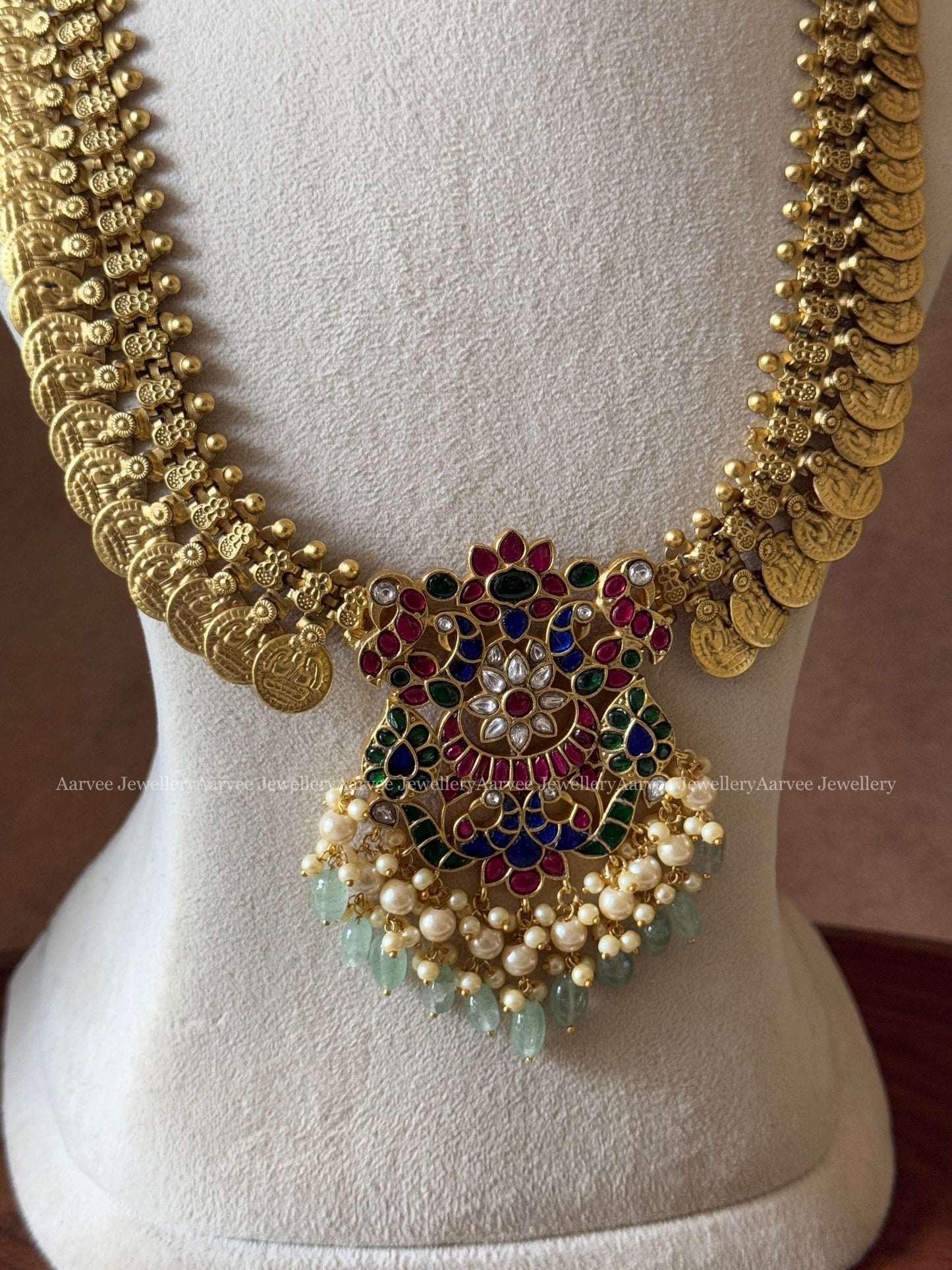 JADAU KUNDAN MID LENGTH GOLD COIN CHAIN WITH PEACOCK& FLORAL PENDANT IN RUBY & BLUE STONES AND PASTEL BEADS