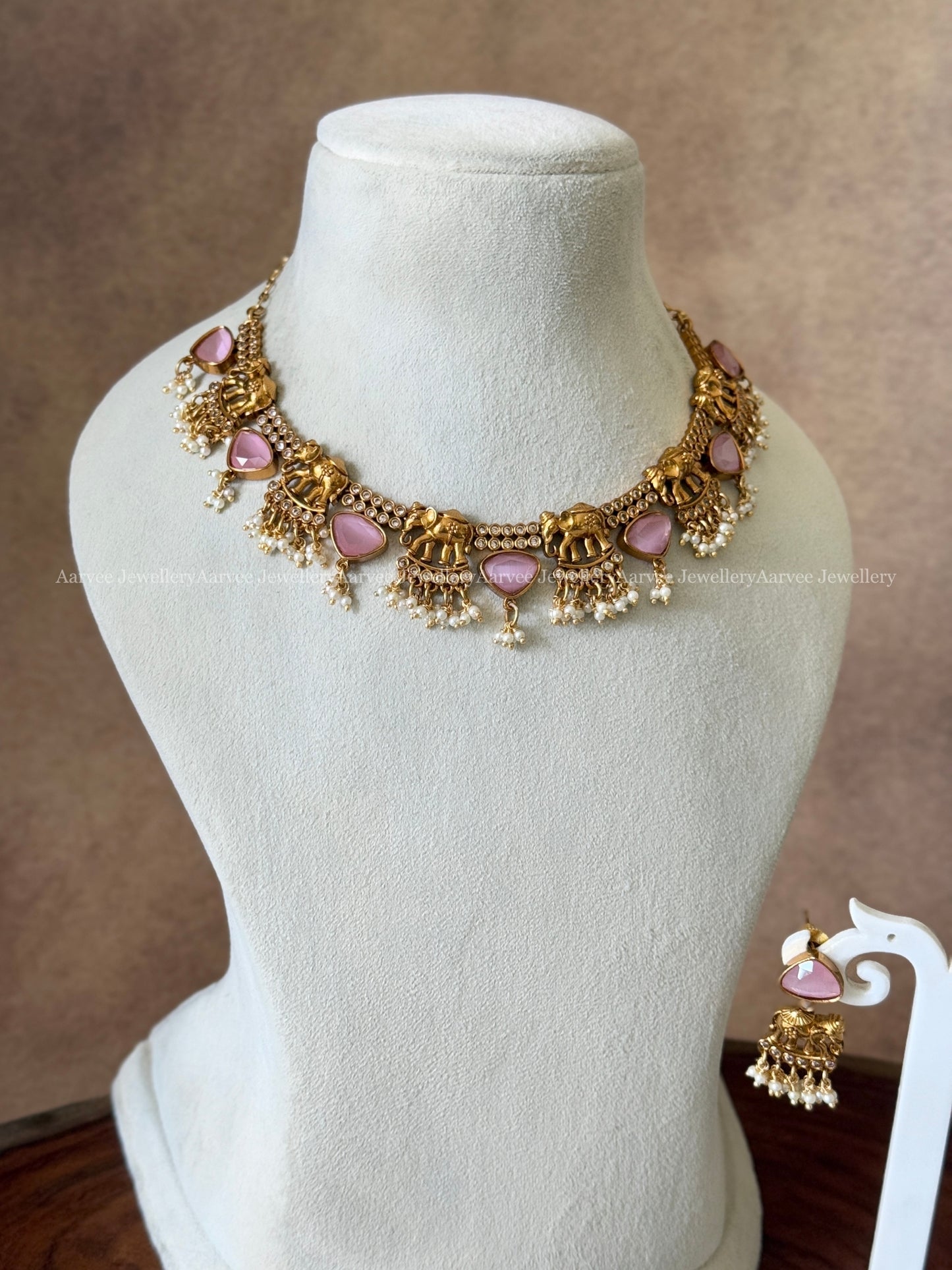 GOLD FINISH ELEPHANT DESIGN NECKLACE SET WITH PASTEL PINK STONES