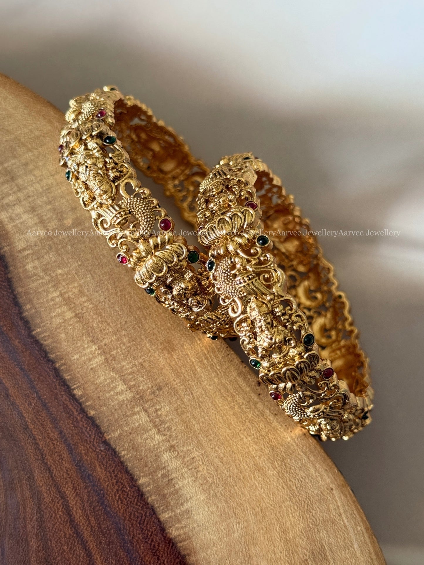 GOLD FINISH LAKSHMI BANGLE WITH RUBY / GREEN STONES