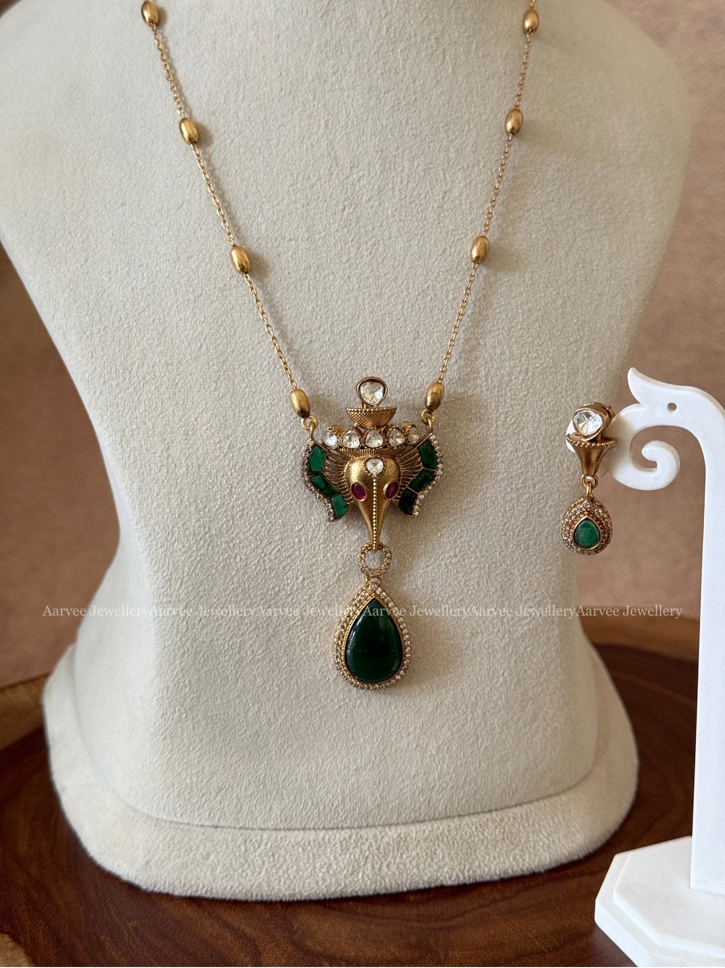 GOLD MID LENGTH CHAIN SET WITH ELEPHANT PENDANT IN GREEN STONES