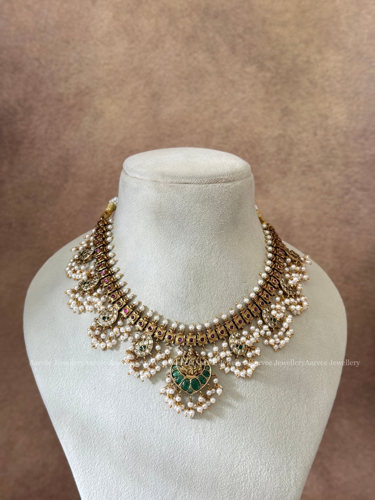 GOLD FINISH GUTTA PUSALU NECKLACE SET WITH LAKSHMI PENDANT AND GREEN STONES