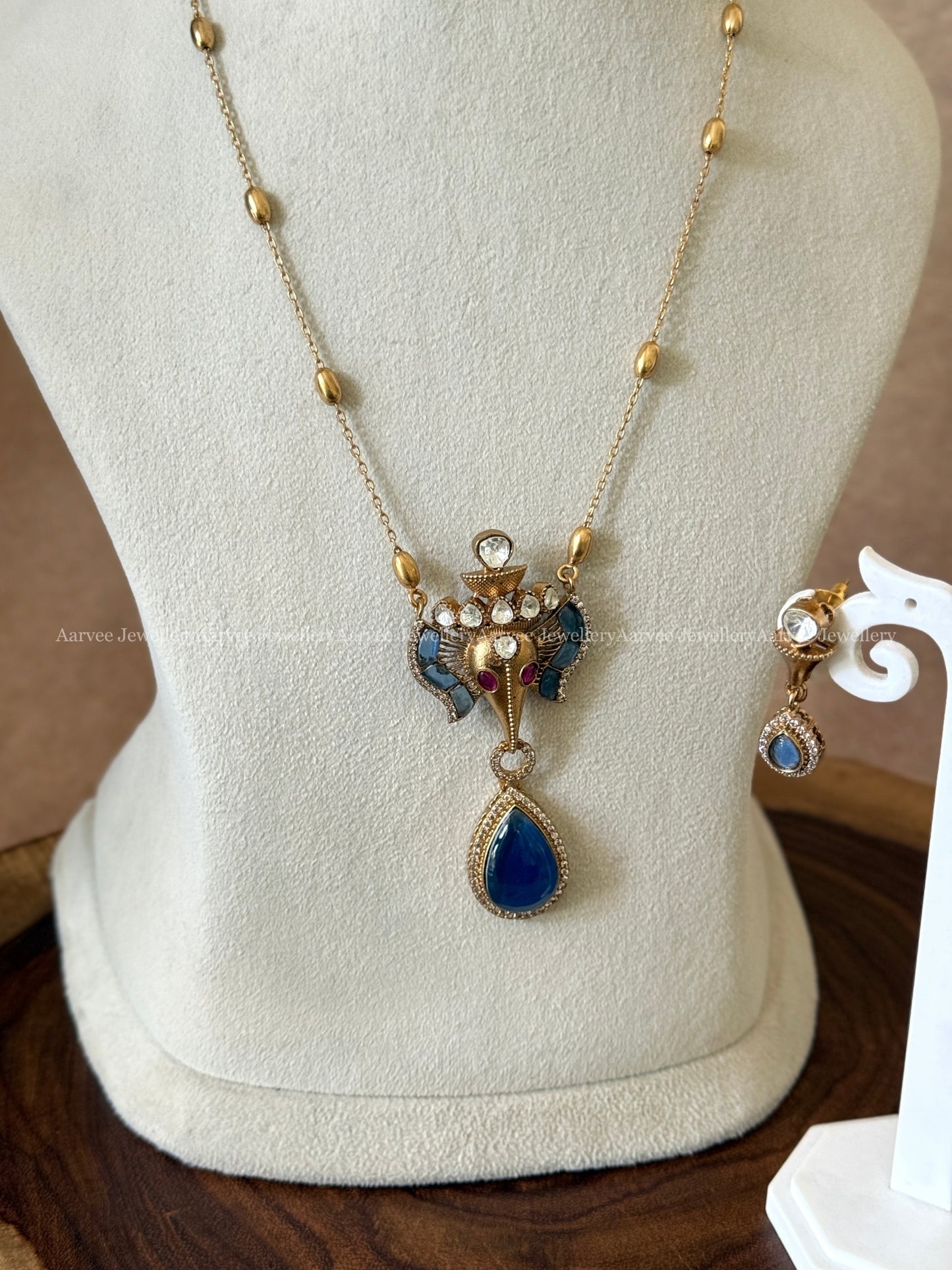 GOLD MID LENGTH CHAIN SET WITH ELEPHANT PENDANT IN BLUE STONES