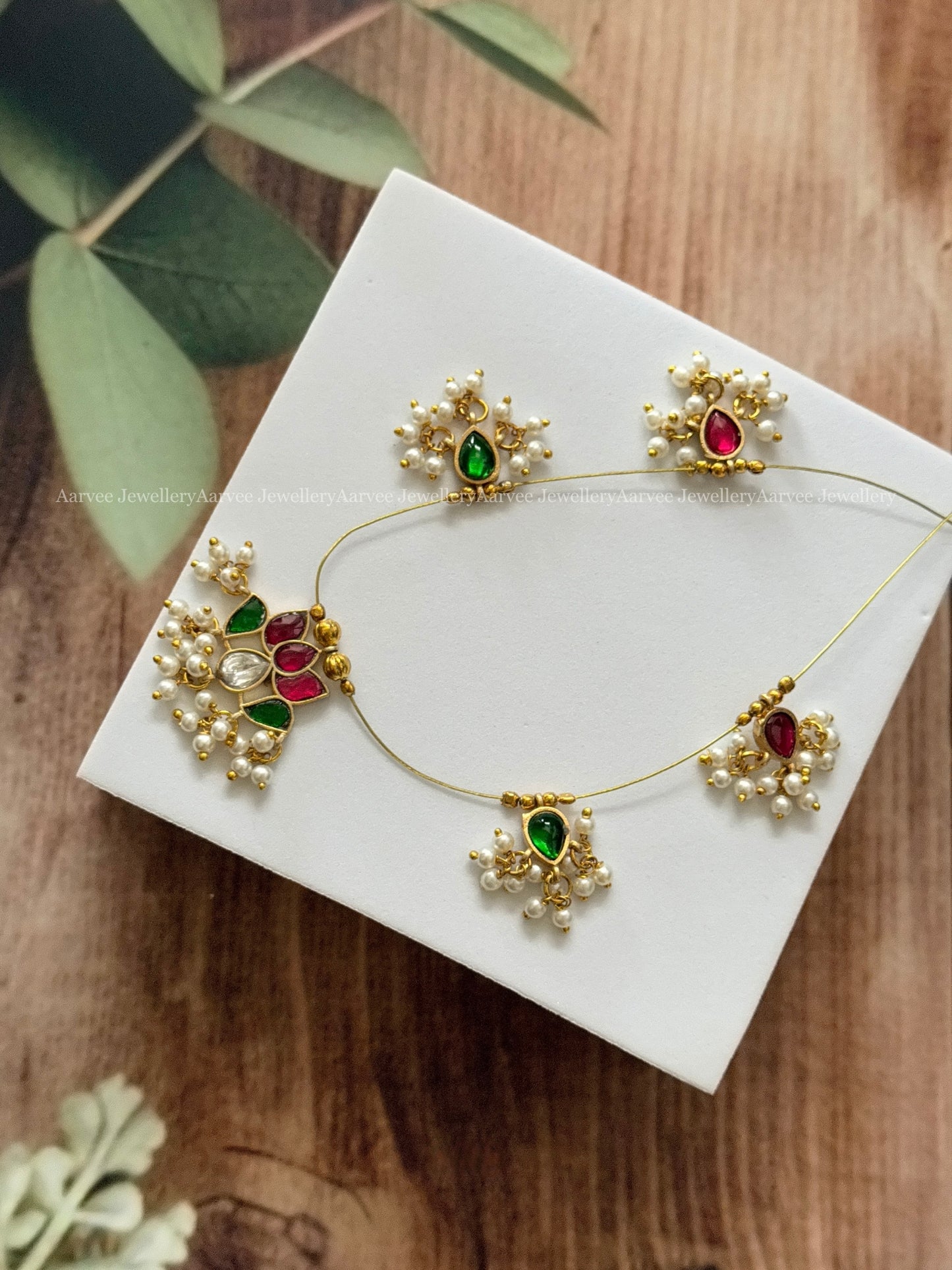 INVISIBLE CHAIN WITH LOTUS PENDANT IN RUBY / GREEN KUNDAN STONE