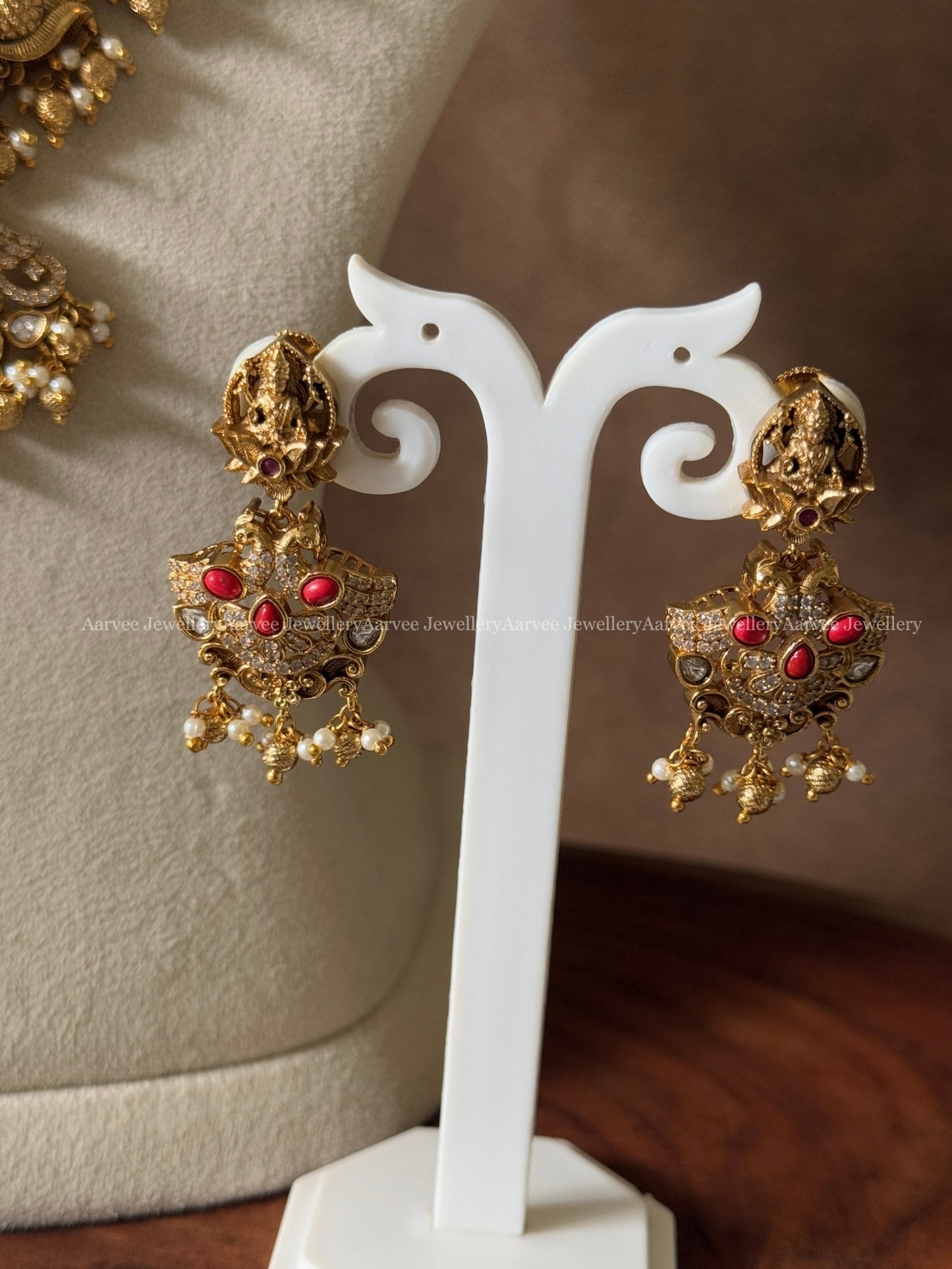 GOLD FINISH MID - LENGTH HARAM WITH LAKSHMI MOTIF AND CORAL STONE