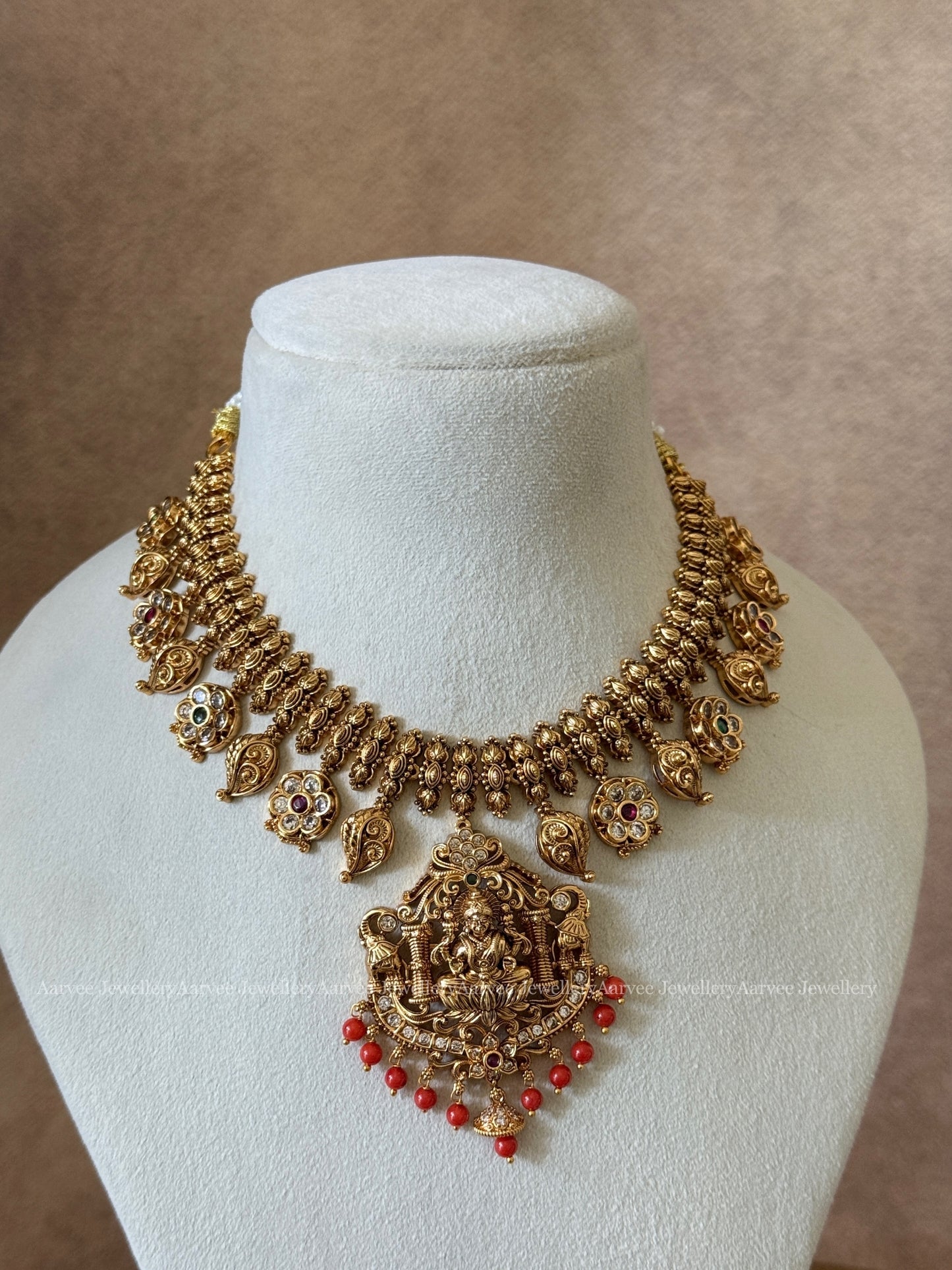 GOLD FINISH LAKSHMI NECKLACE SET WITH CORAL BEADS