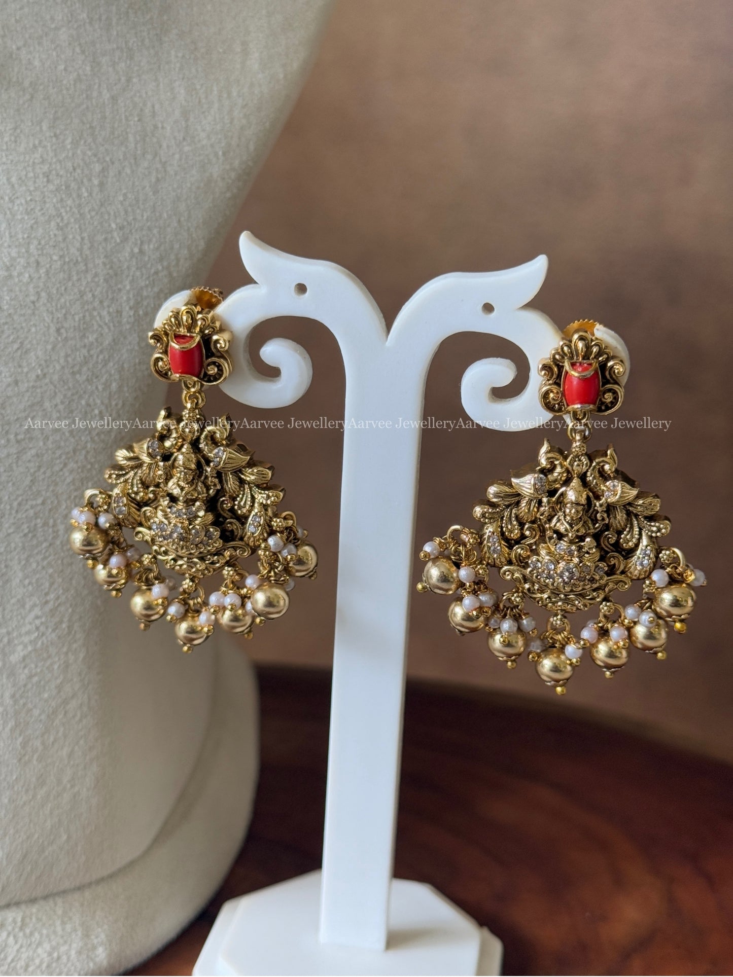GOLD FINISH KANTI NECKLACE SET WITH LAKSHMI PENDANT IN CORAL STONES