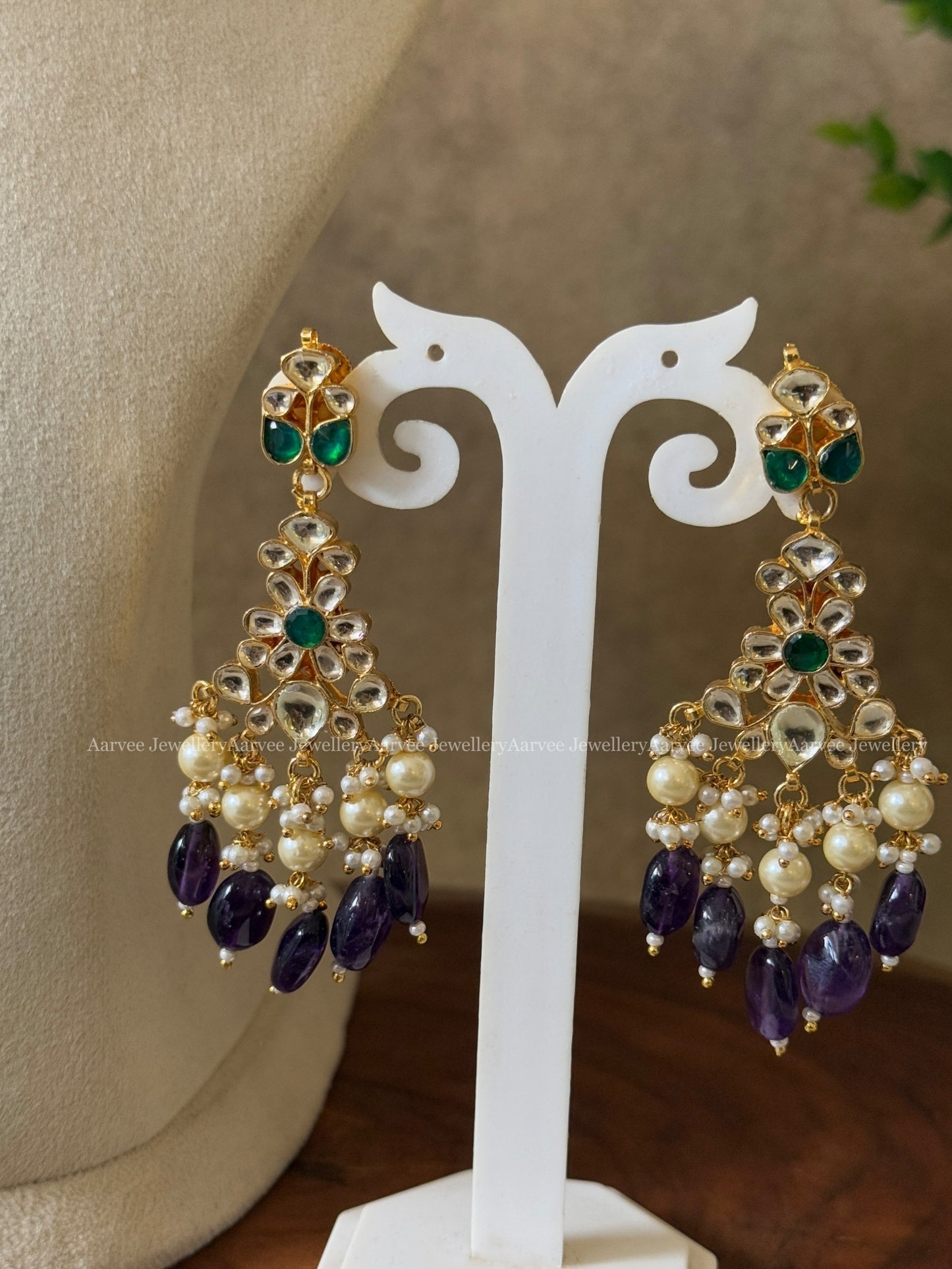 POLKI KUNDAN SET IN TEAR DROP DESIGN AND WITH GREEN STONE AND PURPLE BEADS