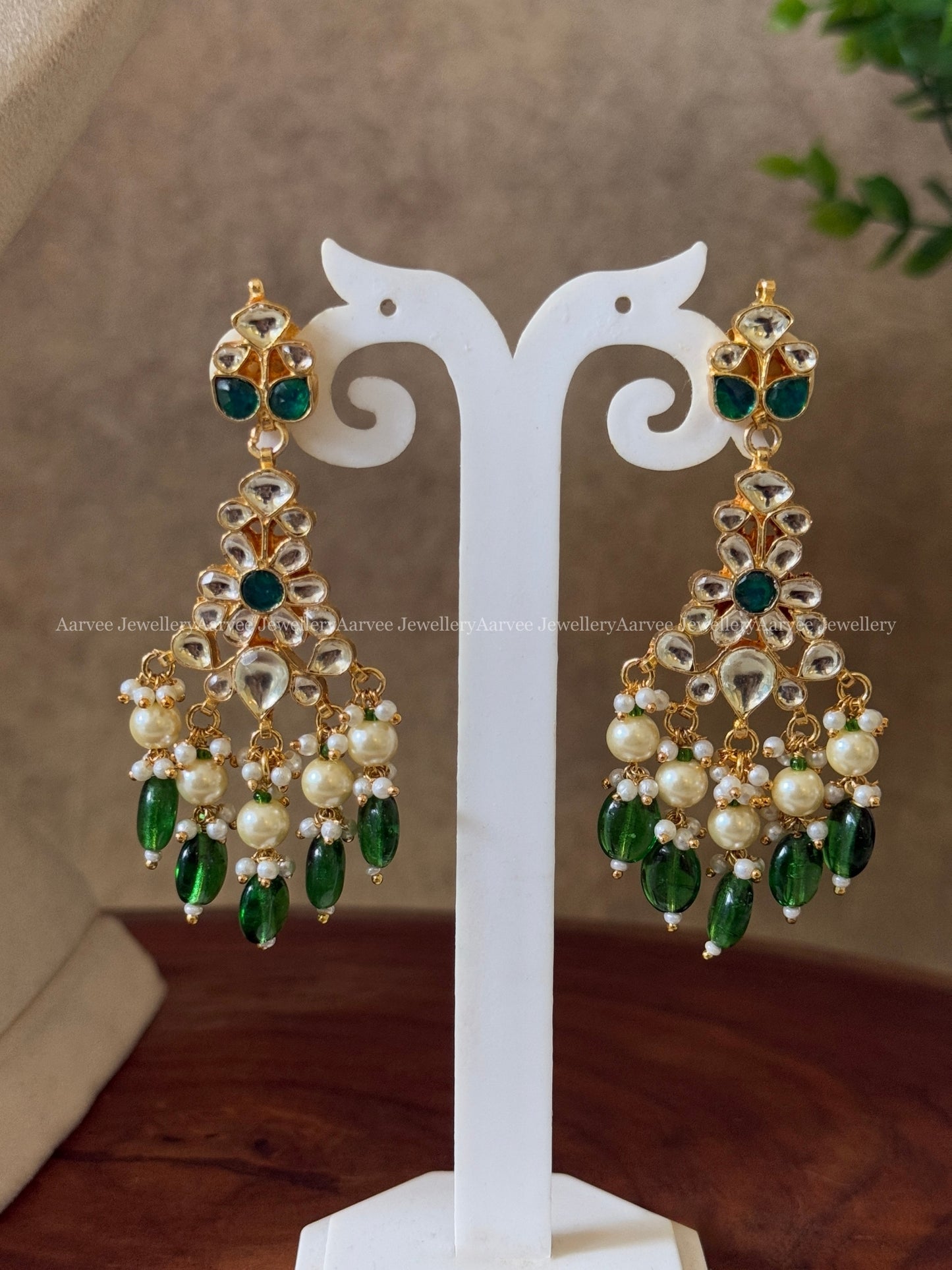 POLKI KUNDAN SET IN TEAR DROP DESIGN AND WITH WHITE STONES AND GREEN BEADS