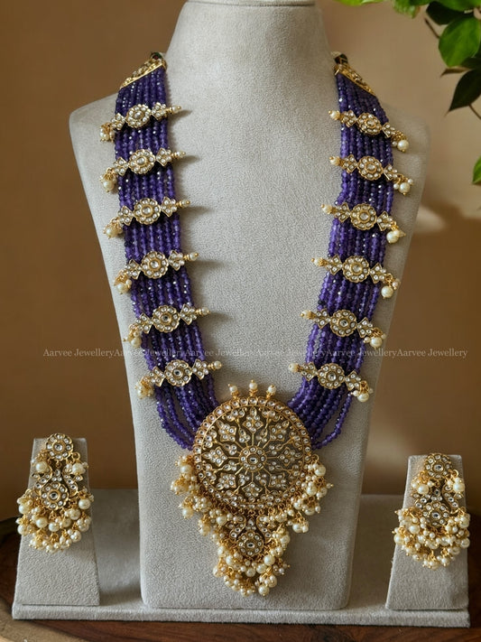 PURPLE BEADED LONG HARAM SET WITH A KUNDAN WHITE STONES PENDANT AND FLORAL SIDE MOTIFS