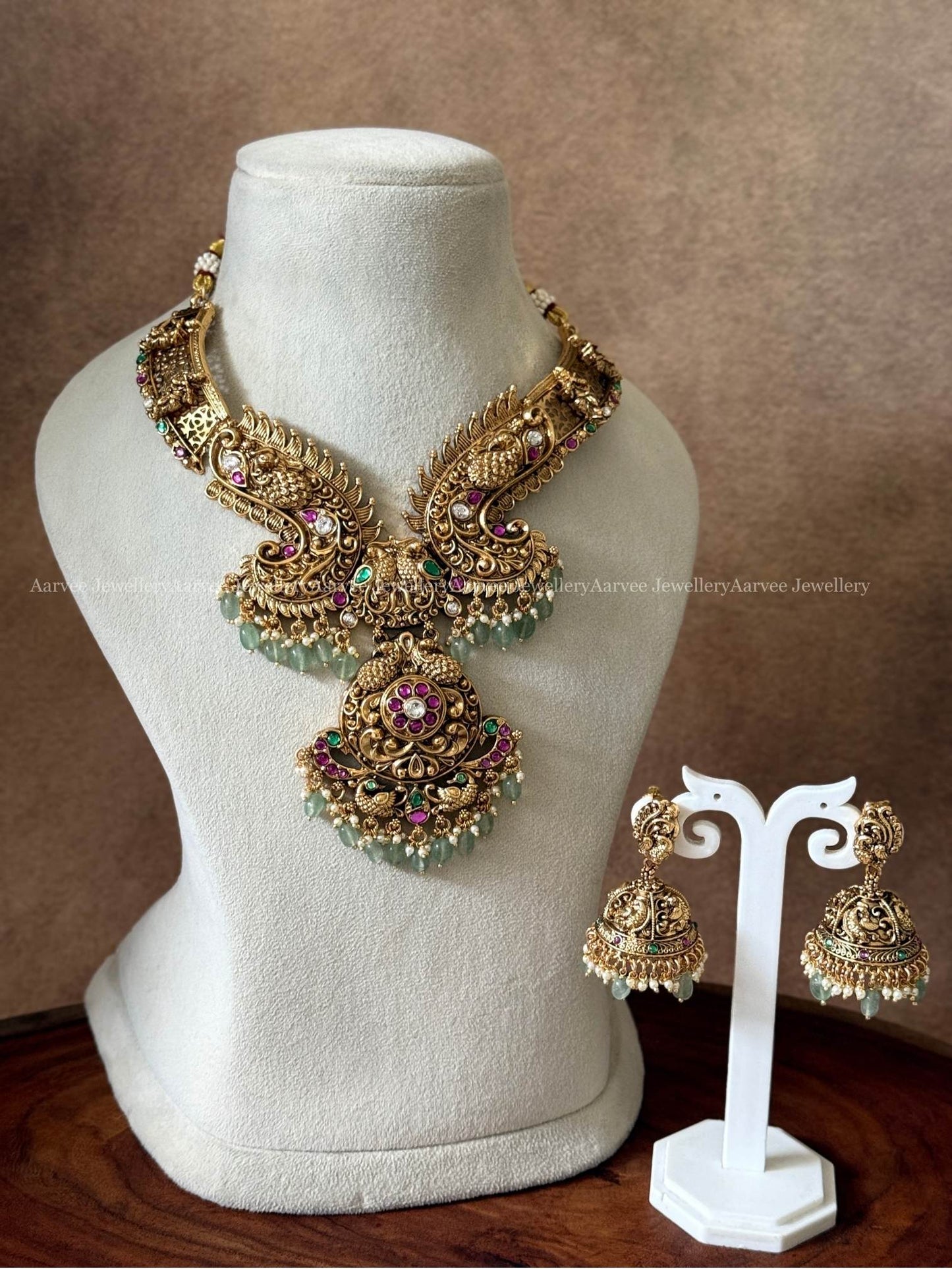 NON IDOL KANTI DESIGN PEACOCK MOTIF NECKLACE SET WITH KUNDAN RUBY/GREEN/WHITE STONES & PASTEL BEADS