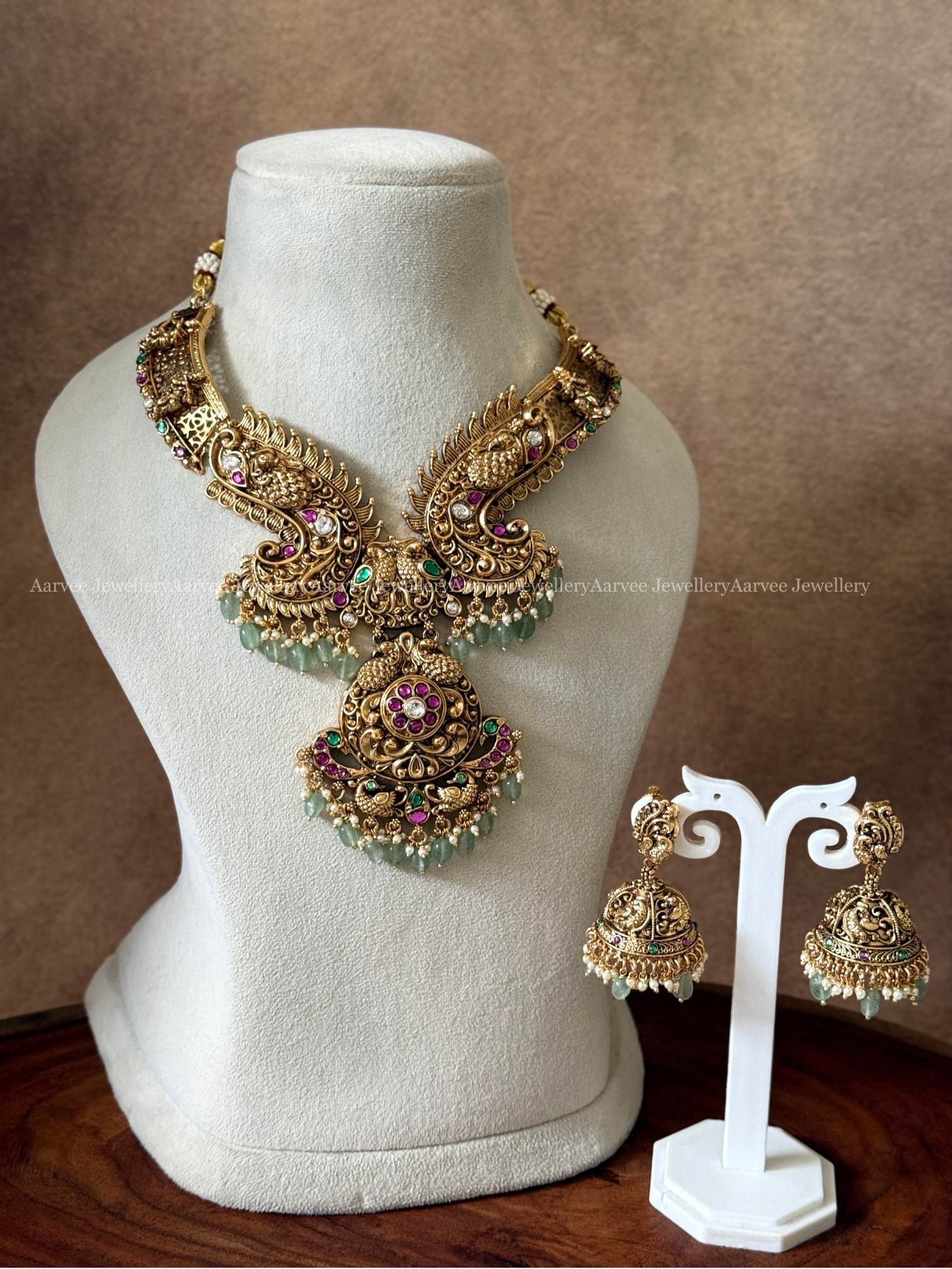 NON IDOL KANTI DESIGN PEACOCK MOTIF NECKLACE SET WITH KUNDAN RUBY/GREEN/WHITE STONES & PASTEL BEADS