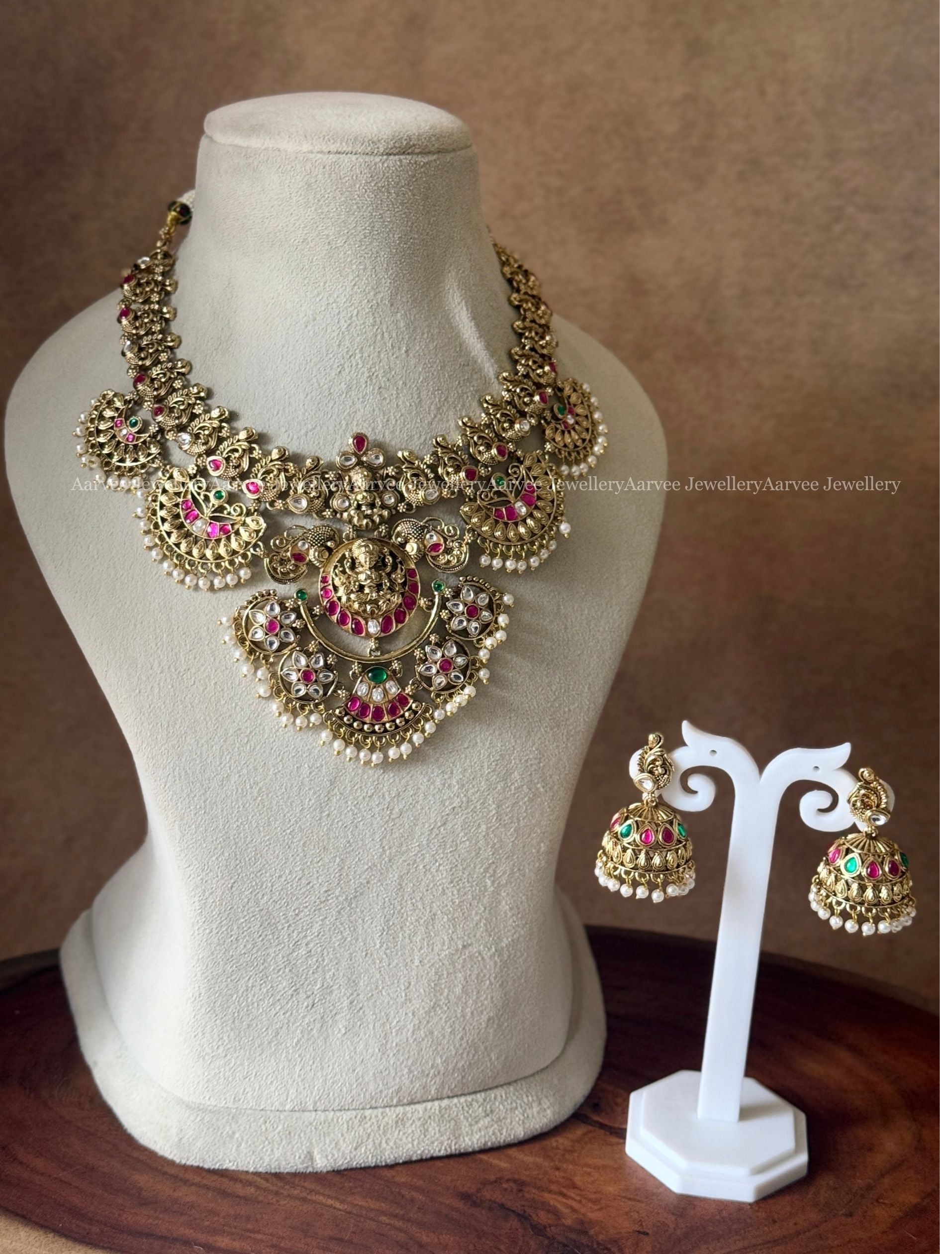 GOLD TONE LAKSHMI MOTIF STATEMENT NECKLACE SET WITH MULTI COLORS KUNDAN STONES