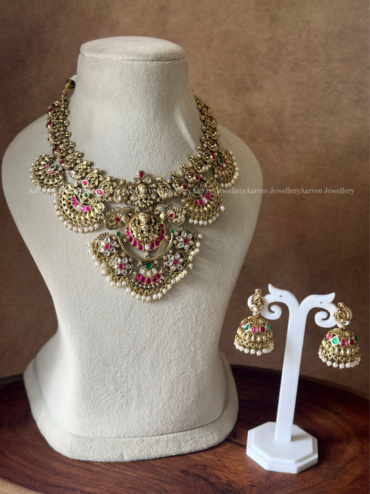 GOLD TONE LAKSHMI MOTIF STATEMENT NECKLACE SET WITH MULTI COLORS KUNDAN STONES