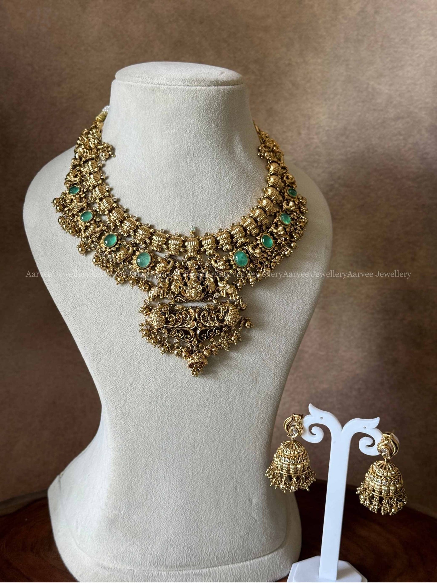 PREMIUM GOLD TONE LAKSHMI NECKLACE SET WITH PASTEL GREEN STONES