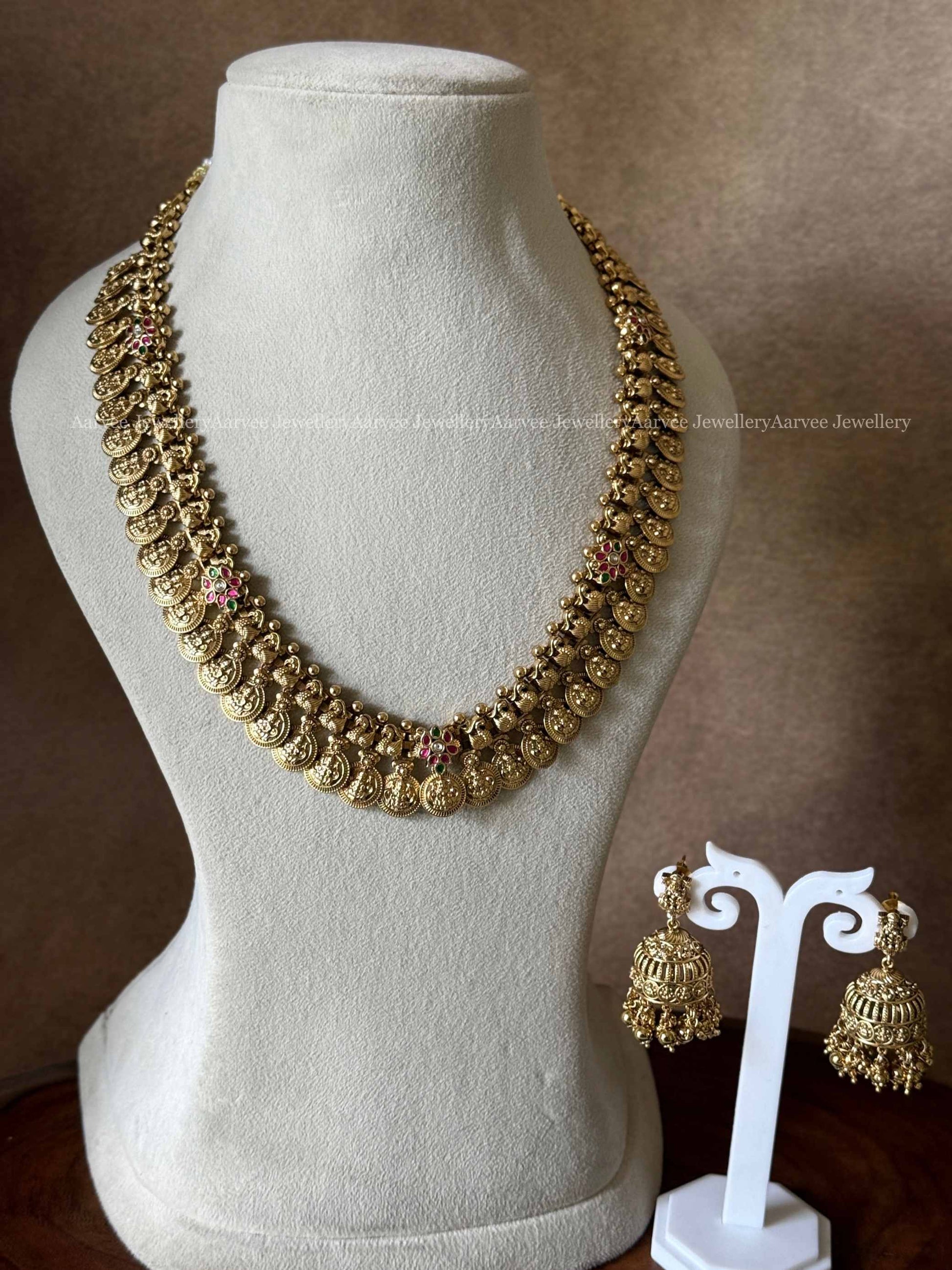 PREMIUM GOLD TONE LAKSHMI NECKLACE SET WITH PASTEL GREEN STONES