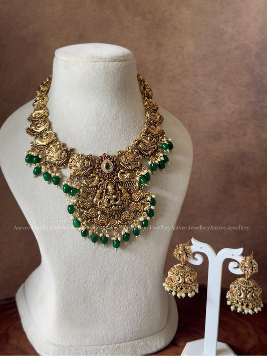 GOLD FINISH PEACOCK & LAKSHMI NECKLACE SET WITH GREEN BEADS