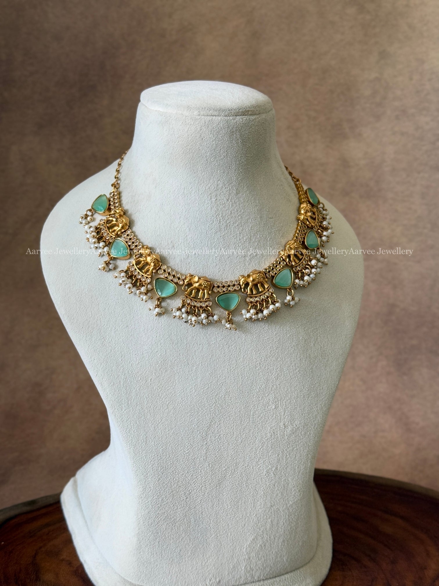 GOLD FINISH ELEPHANT DESIGN NECKLACE WITH PASTEL BLUE STONES