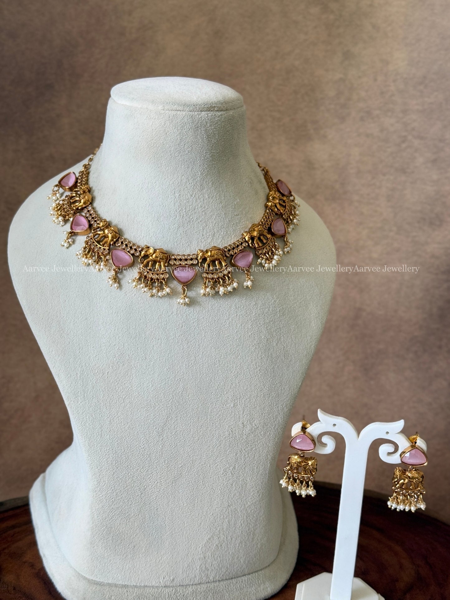 GOLD FINISH ELEPHANT DESIGN NECKLACE SET WITH PASTEL PINK STONES