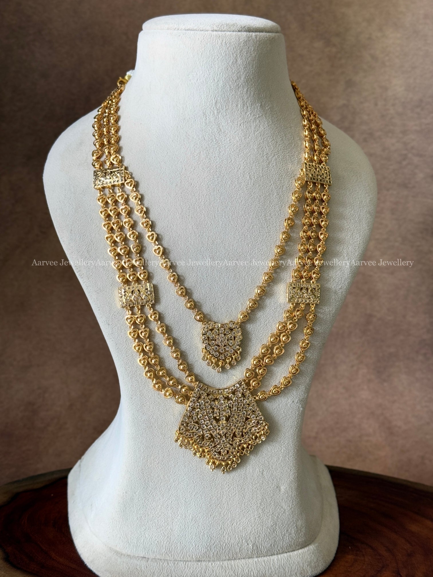 GOLD FINISH LAYERED INPHON MID LENGTH HARAM SET WITH WHITE STONE