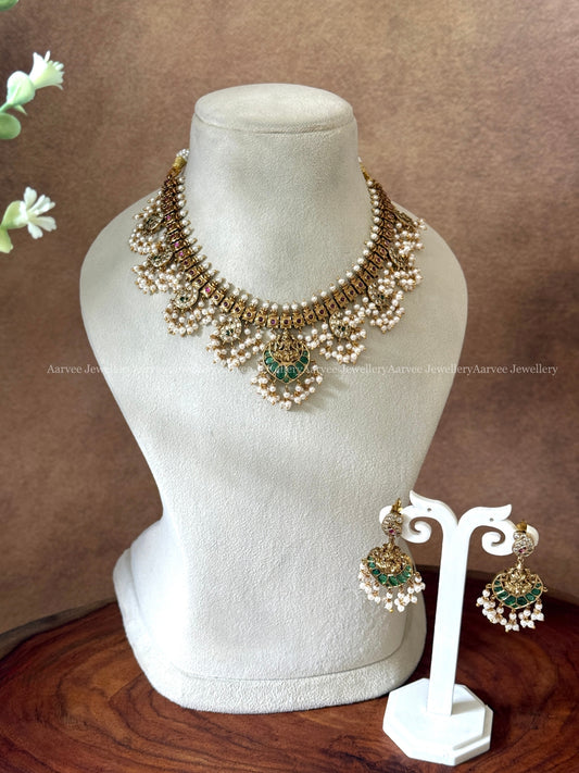 GOLD FINISH GUTTA PUSALU NECKLACE SET WITH LAKSHMI PENDANT AND GREEN STONES