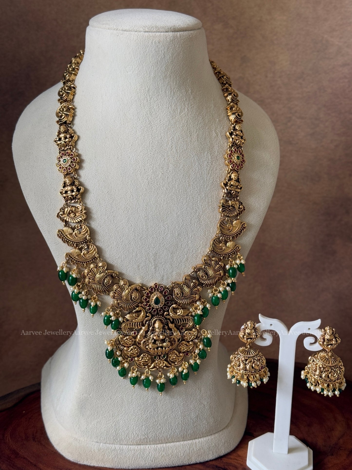 GOLD FINISH HARAM SET WITH LAKSHMI & PEACOCK DESIGN PENDANT AND WITH GREEN BEADS