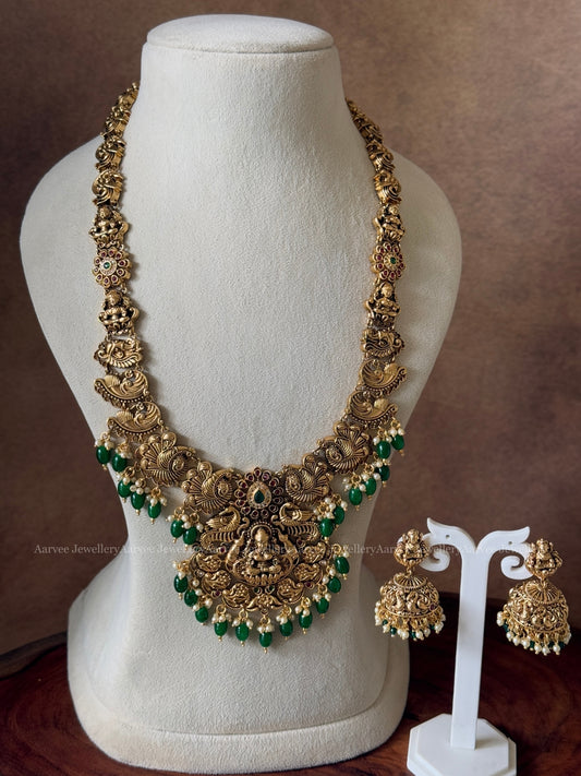GOLD FINISH HARAM SET WITH LAKSHMI & PEACOCK DESIGN PENDANT AND WITH GREEN BEADS