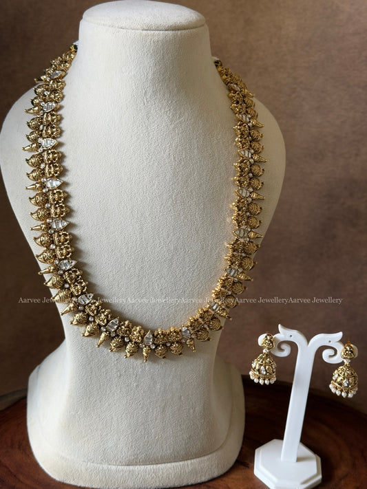 ANTIQUE GOLD TONE LAKSHMI AND WHITE STONE HARAM SET