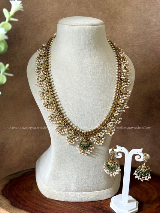 GOLD FINISH GUTTA PUSALU HARAM SET WITH LAKSHMI PENDANT AND GREEN STONES