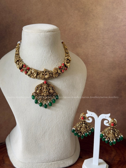 GOLD FINISH CORAL STONE KANTI NECKLACE SET WITH LAKSHMI PENDANT AND GREEN BEADS