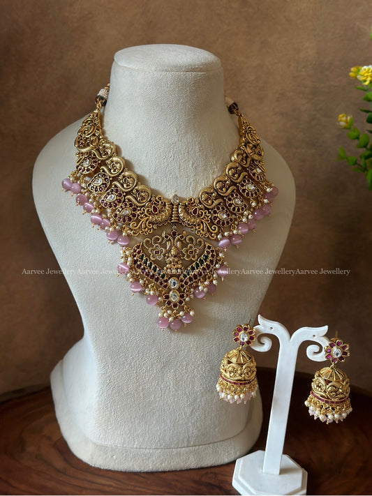 GOLD FINISH PEACOCK NECKLACE SET WITH PASTAL PINK BEADS