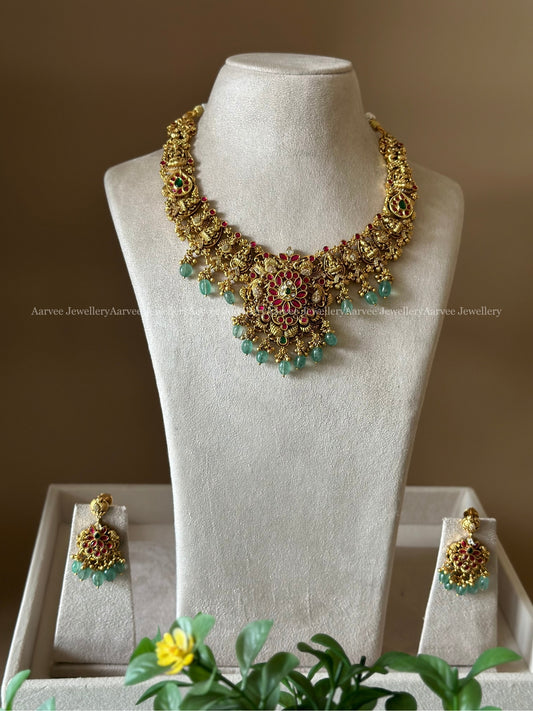 GOLD FINISHED LAKSHMI & FLORAL NECKLACE SET WITH PASTEL BEADS
