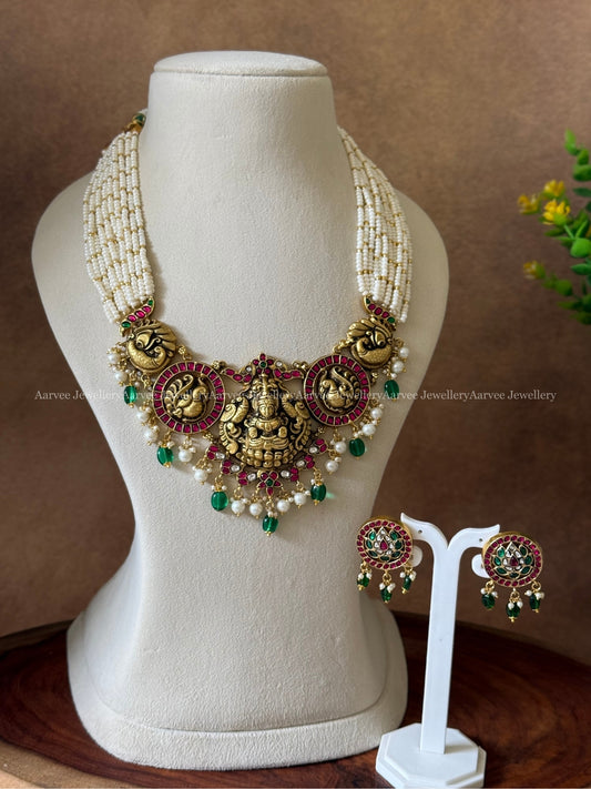 JADAU KUNDAN PEARL BUNCH LAYERED MID LENGTH NECKLACE SET WITH NAKSHI & PEACOCK PENDANT WITH GREEN BEADS