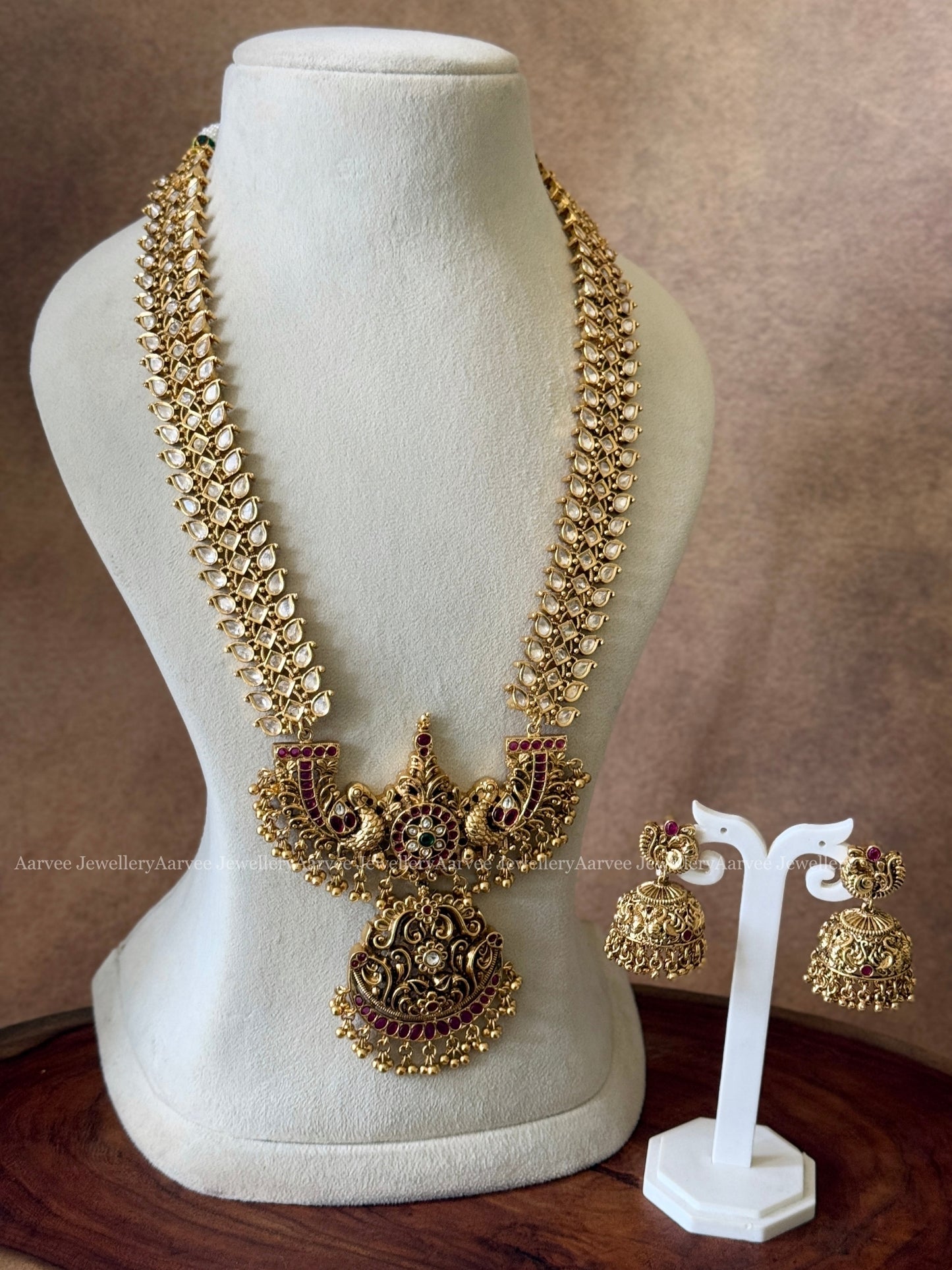 WHITE STONE HARAM WITH PEACOCK PENDANT IN RUBY STONES & GOLD BEADS