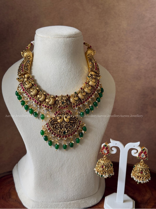 GOLD FINISH KANTI PEACOCK NECKLACE SET WITH GREEN BEADS