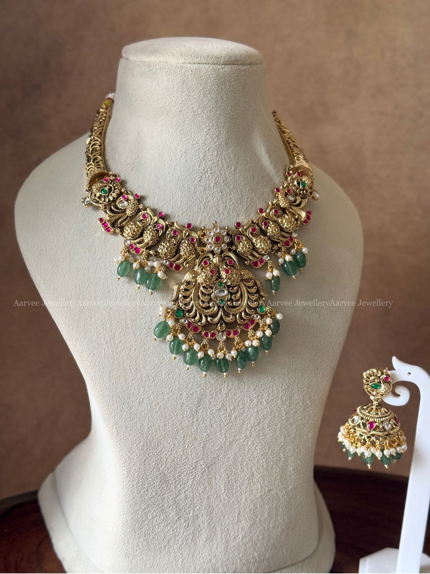 GOLD TONE PINK KUNDAN STONE PEACOCK MOTIF KANTI NECKLACE SET WITH GREEN BEADS