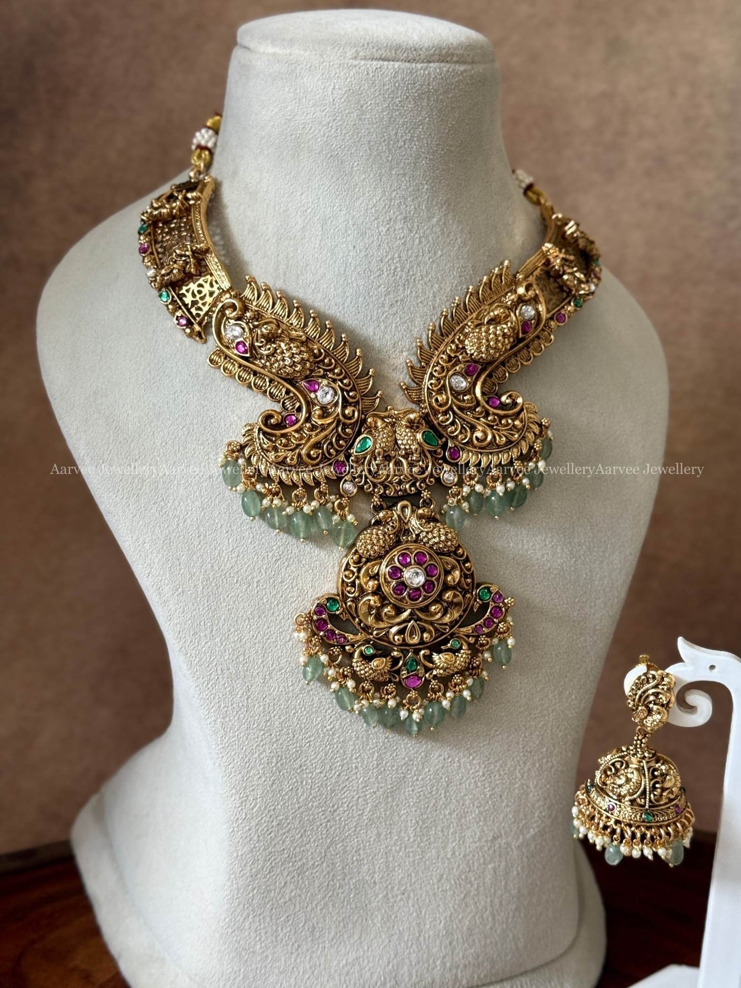 NON IDOL KANTI DESIGN PEACOCK MOTIF NECKLACE SET WITH KUNDAN RUBY/GREEN/WHITE STONES & PASTEL BEADS