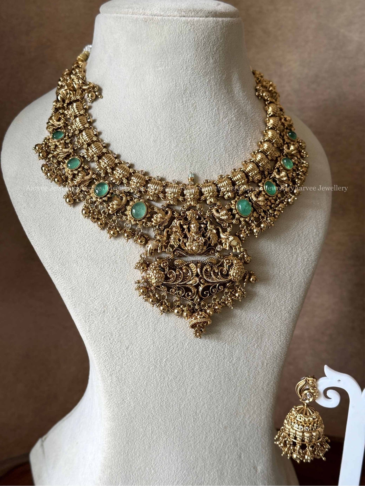 PREMIUM GOLD TONE LAKSHMI NECKLACE SET WITH PASTEL GREEN STONES