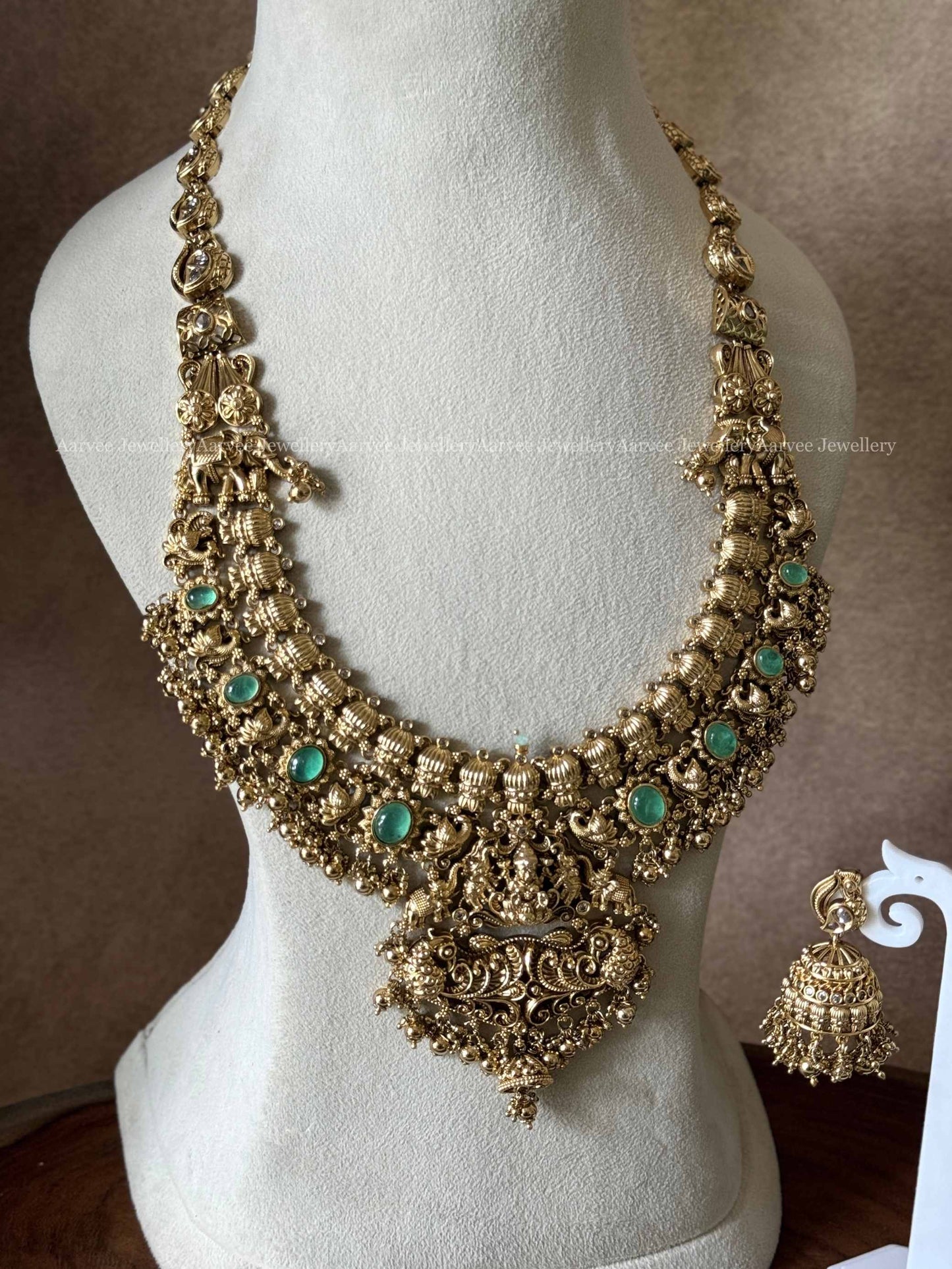 PREMIUM GOLD TONE LAKSHMI HARAM SET WITH PASTEL GREEN STONES