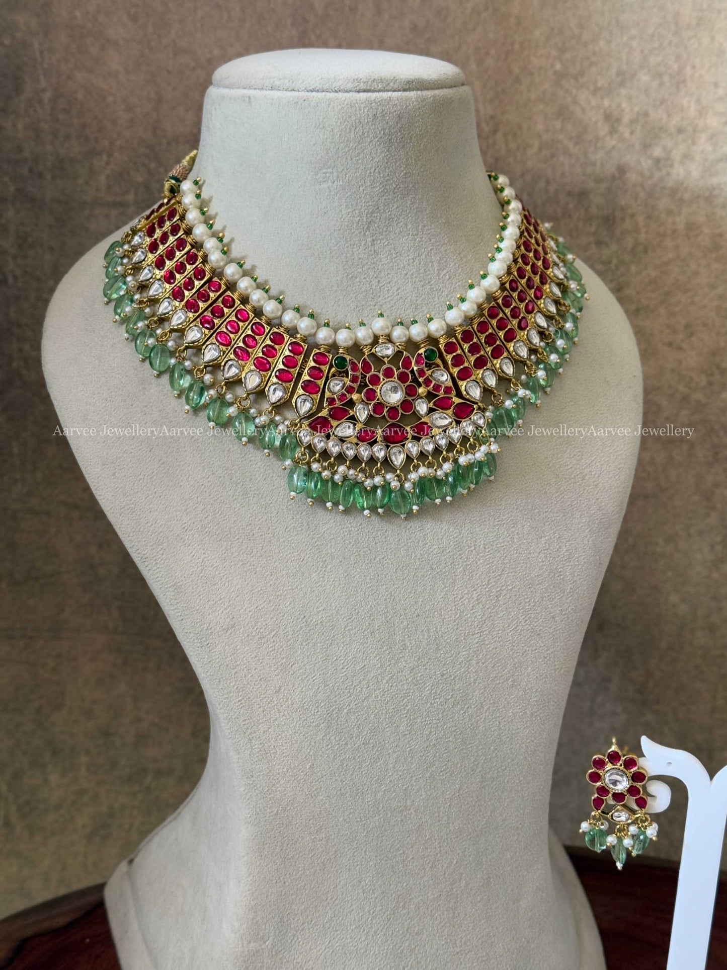 JADAU KUNDAN RUBY STONE NECKLACE SET WITH PEACOCK DESIGN AND PASTEL GREEN BEADS