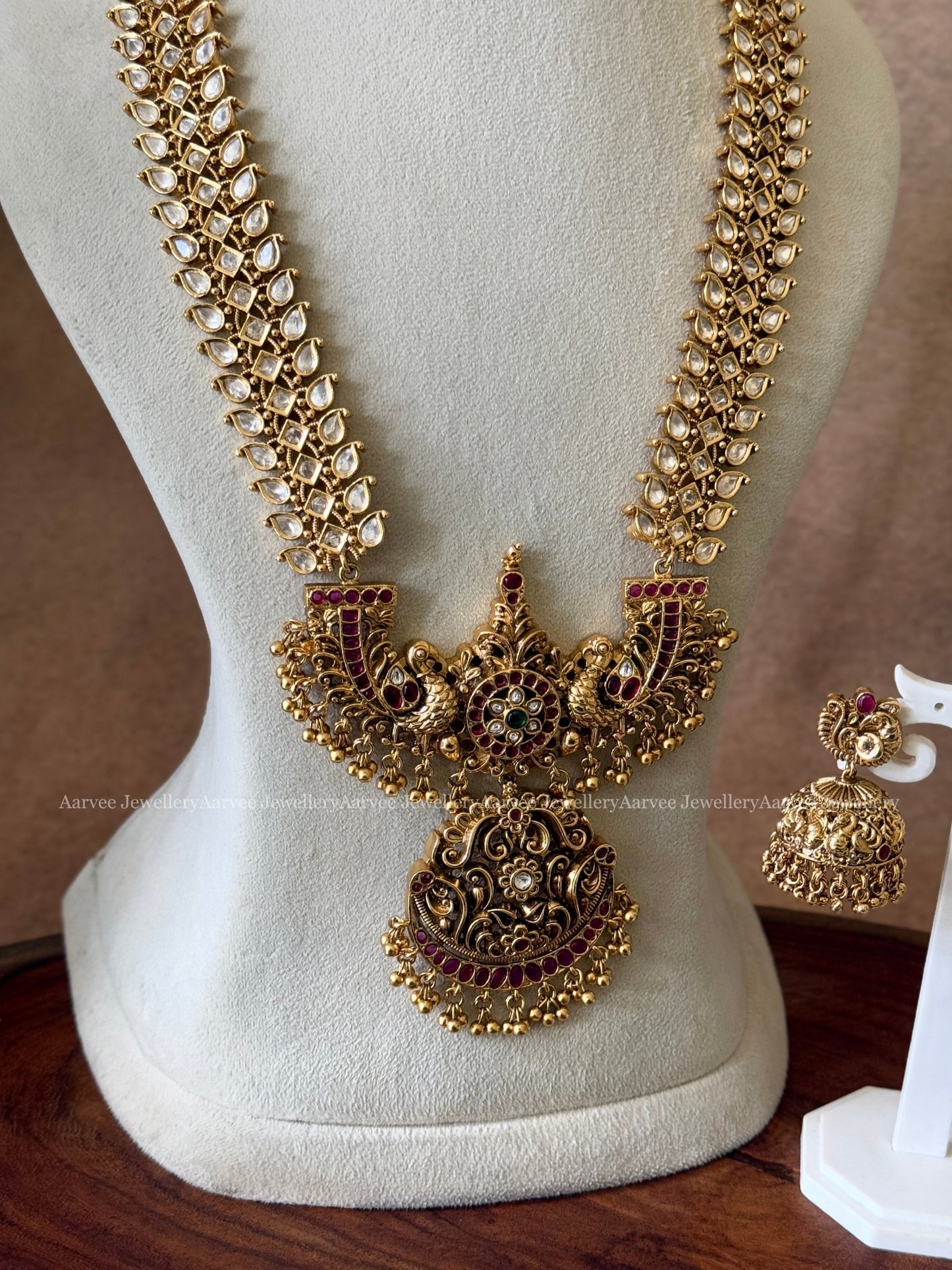 WHITE STONE HARAM WITH PEACOCK PENDANT IN RUBY STONES & GOLD BEADS