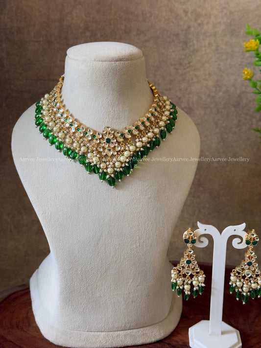 POLKI KUNDAN SET IN TEAR DROP DESIGN AND WITH WHITE STONES AND GREEN BEADS