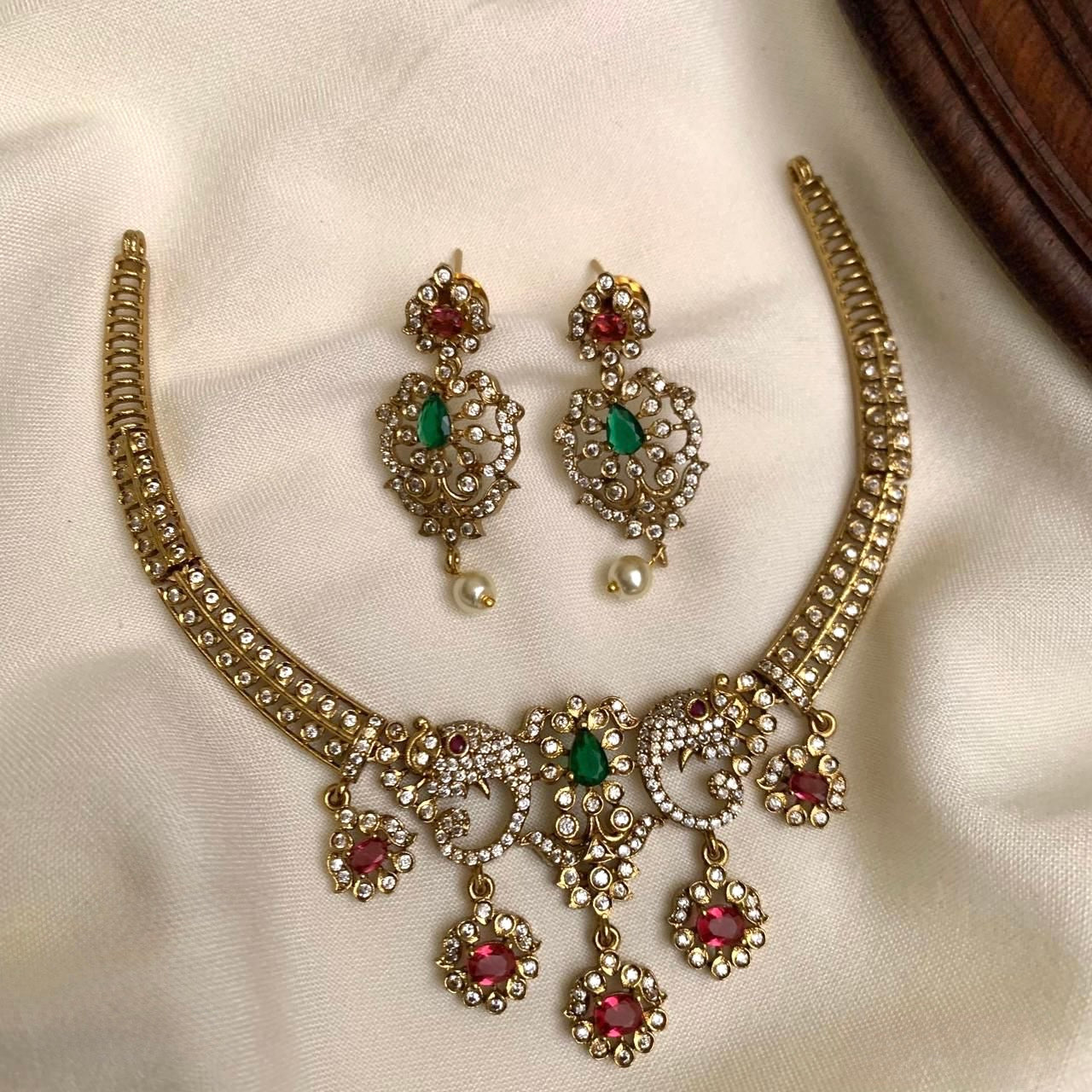 MINIMAL GOLD FINISH KANTI NECKLACE SET WITH RUBY / GREEN CZ STONES
