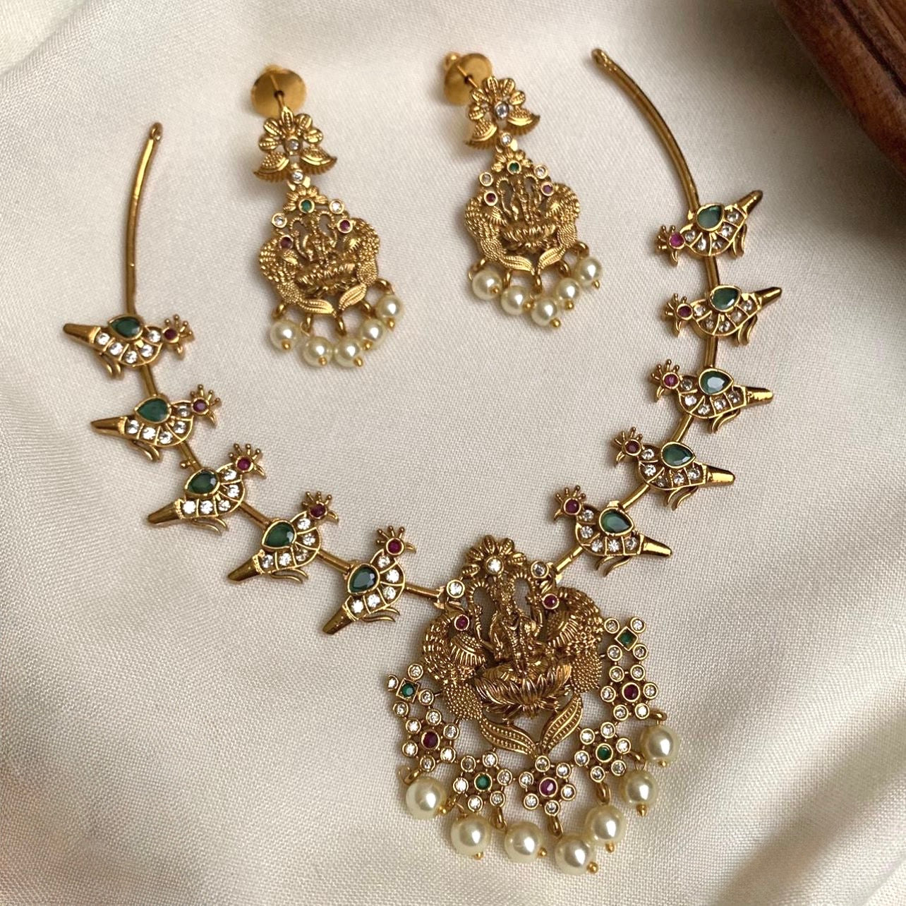 GOLD HASLI NECKLACE SET WITH PARROT AND LAKSHMI PENDANT